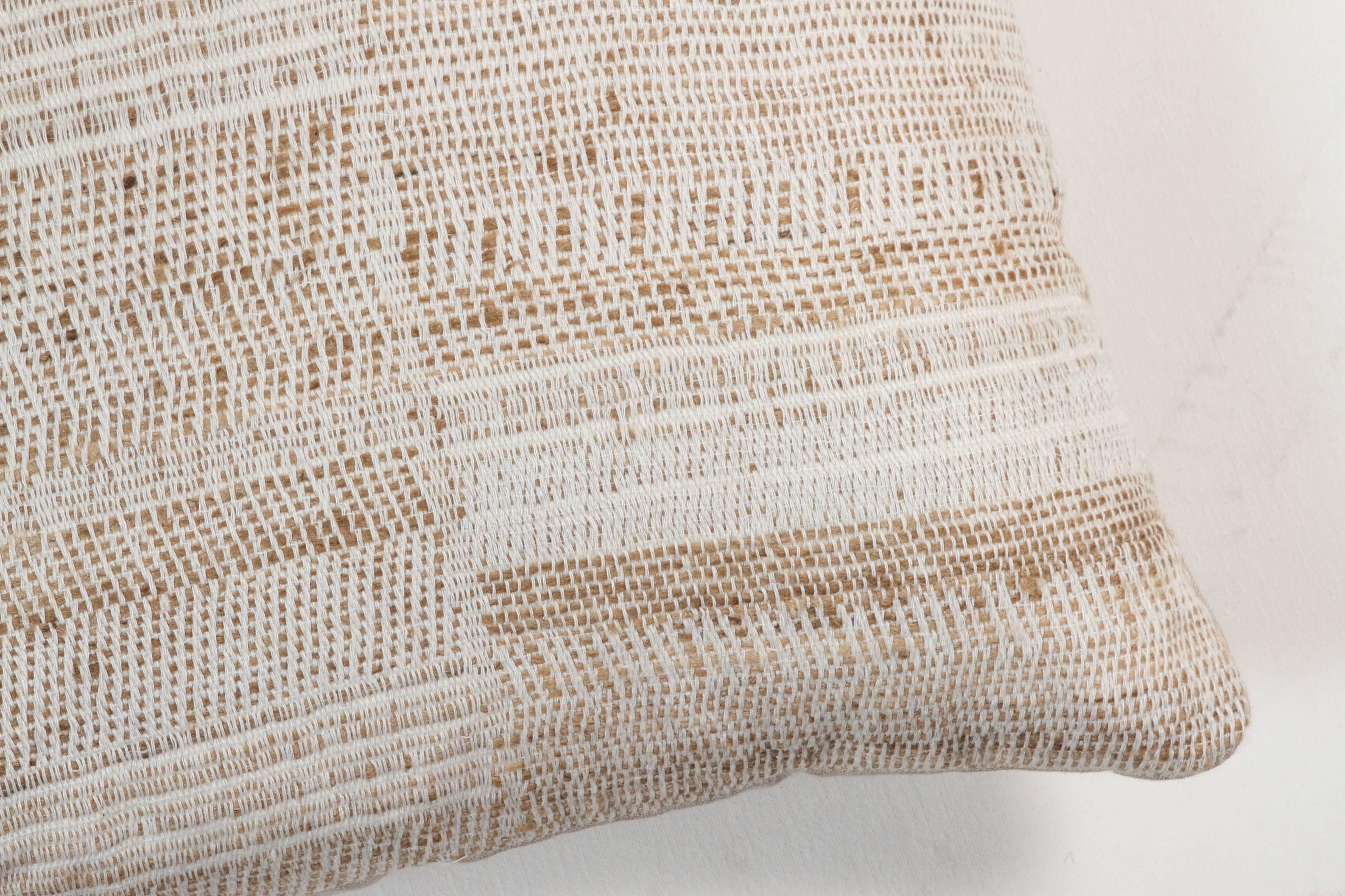A contemporary line of cushions, pillows, throws, bedcovers, bedspreads and yardage hand woven in India on antique Jacquard looms. Handspun wool, cotton, linen, and raw silk give the textiles an appealing uneven quality.

This wool and raw tussar