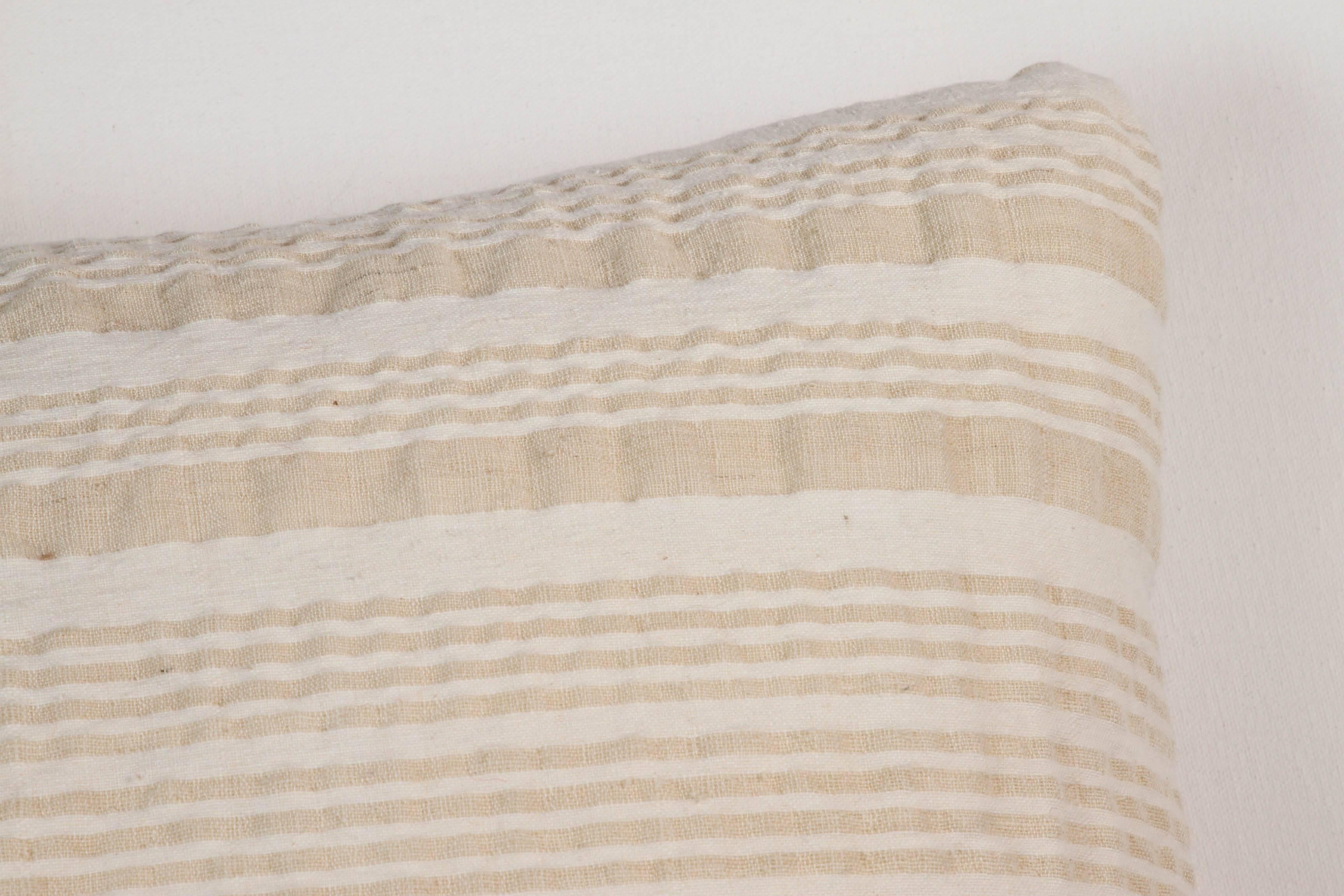 Hemp and cotton mixed striped, hand woven, vintage textile. Off-white and oatmeal color. Pillow same on both side with an invisible zipper and feather and down fill.