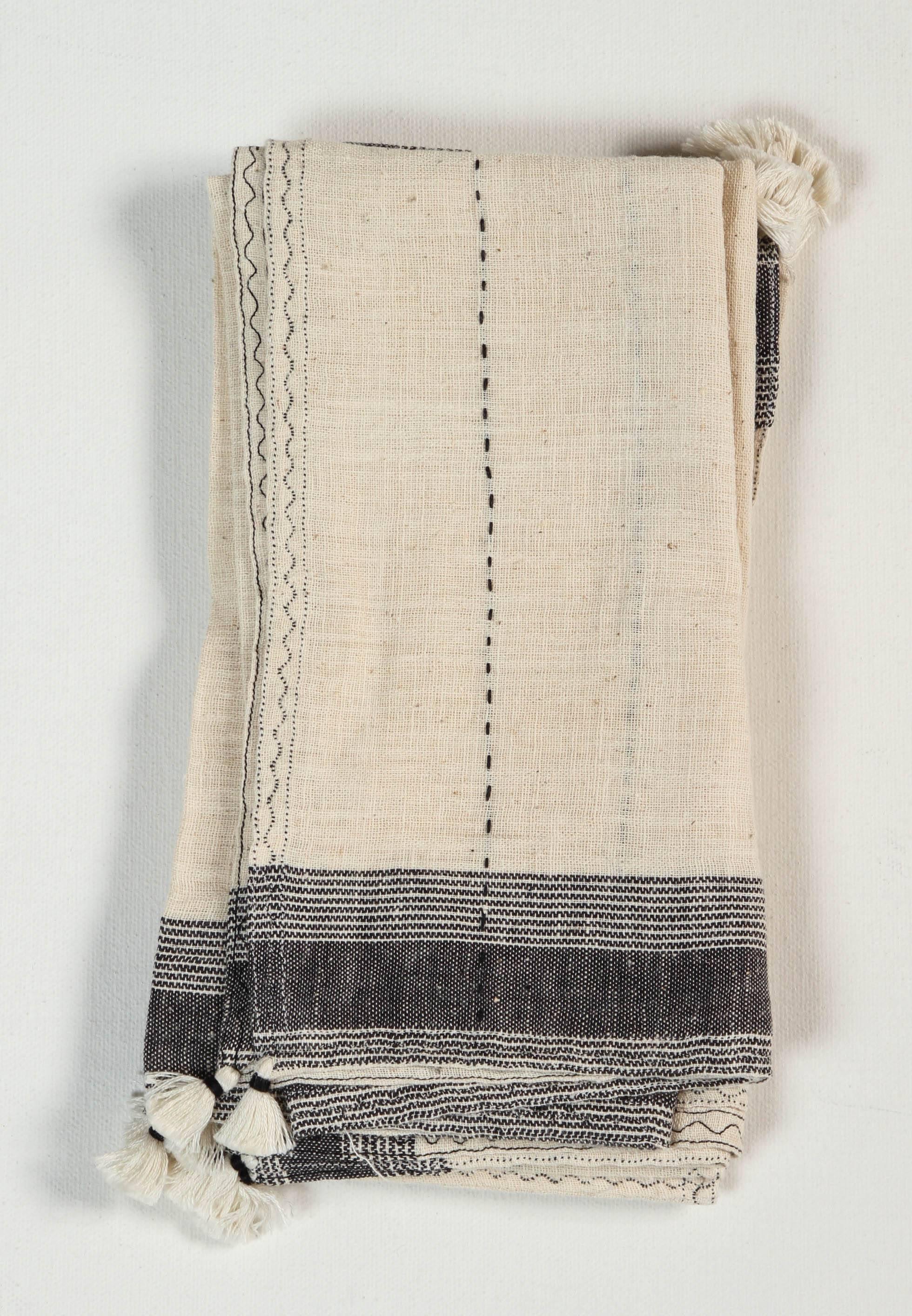 Pat McGann Workshop
Kala naturally dyed organic cotton from Gujarat, India. Hand loomed using traditional Indian textile techniques to produce extra weft woven stripes and plaids. The black and ivory napkins have added hand-knotted tassels. Areas of