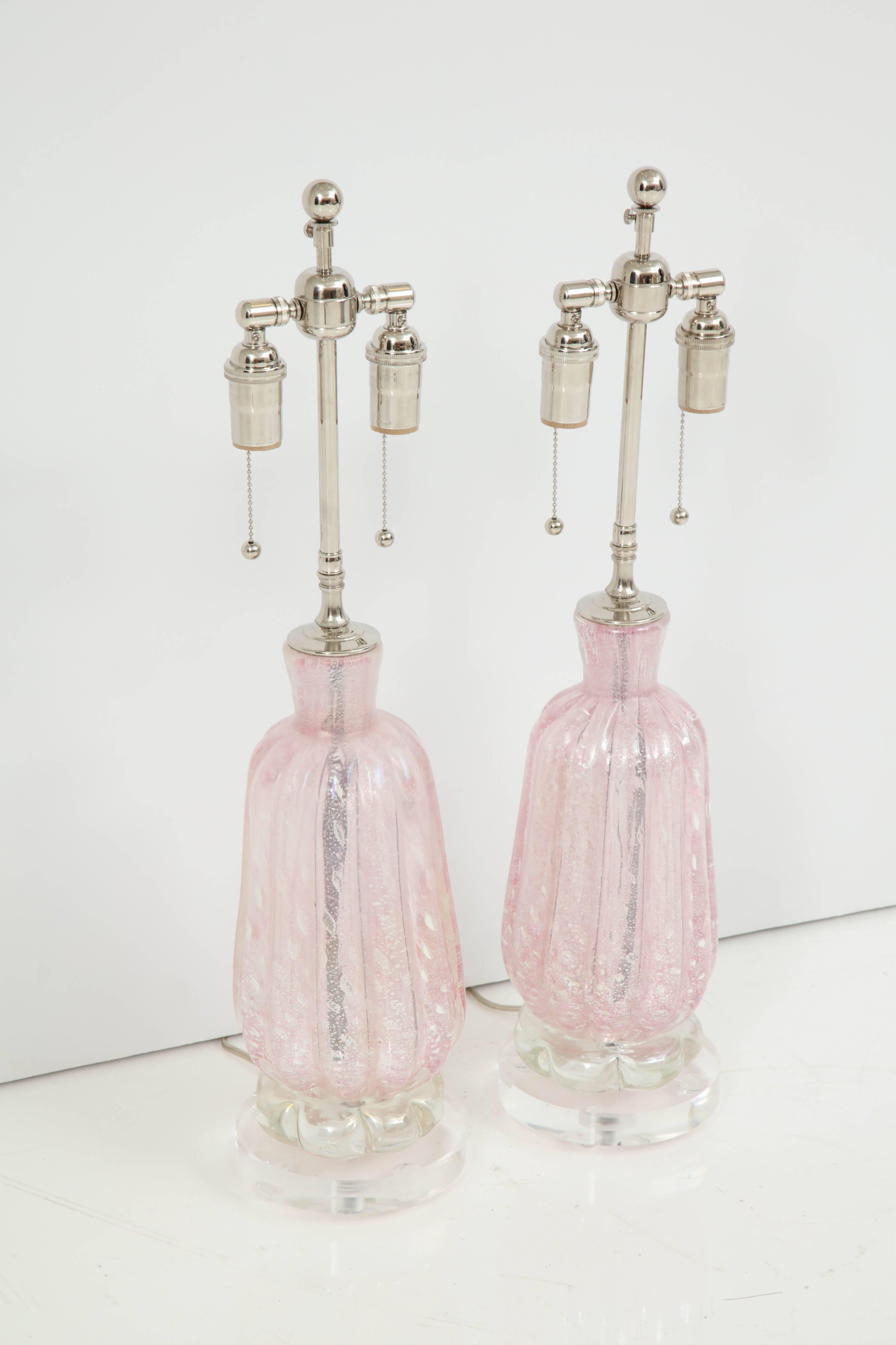 Beautiful pair of candy pink Murano lamps with controlled bubbles.
The lamps sit on thick Lucite bases and they have been newly rewired with polished
Nickel double clusters that take standard light bulbs.