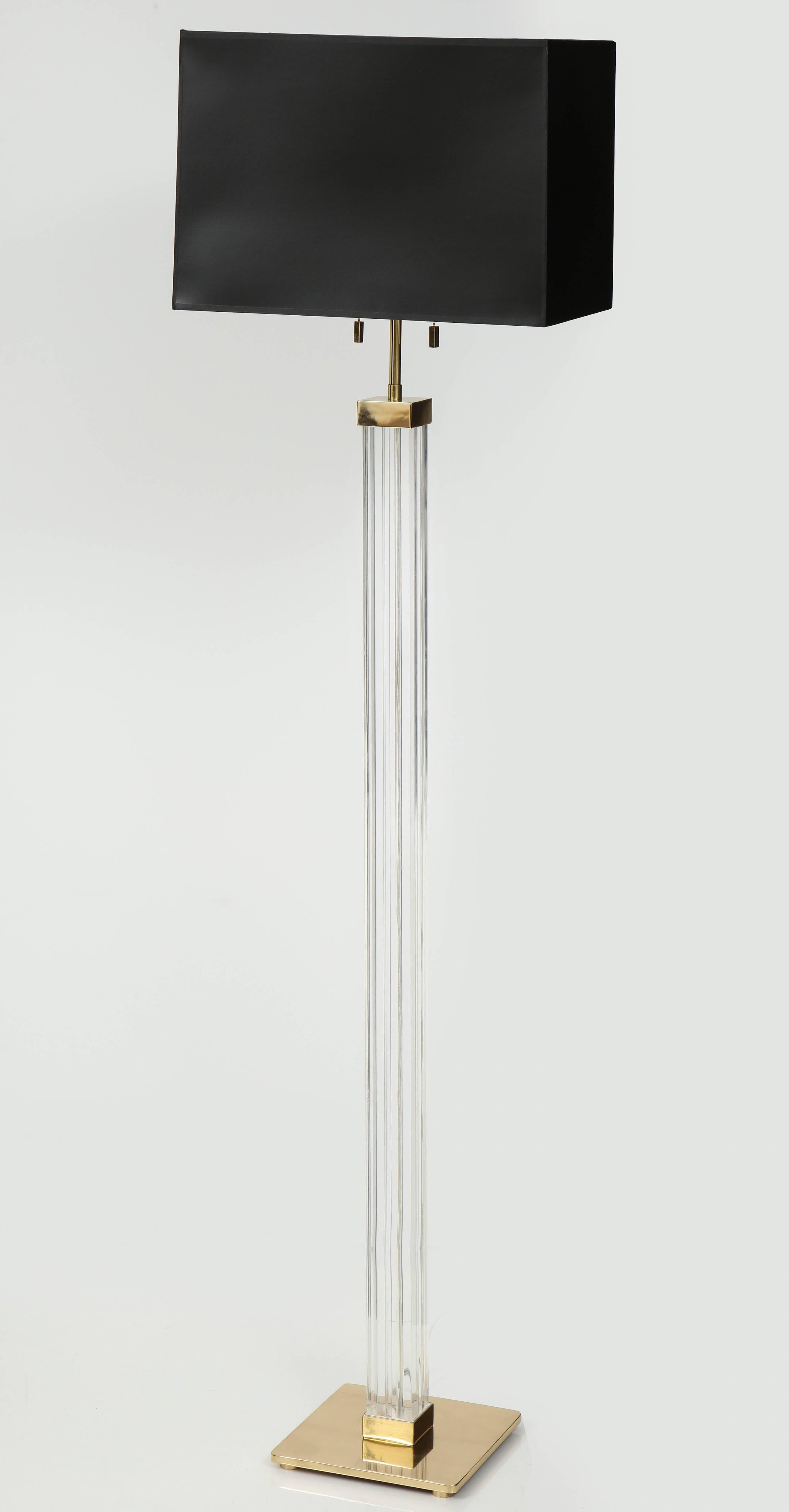 Lucite column floor lamp with a square brass base and double pull chain sockets, designed by Karl Springer. Rewired for use in the USA. Shade not included.