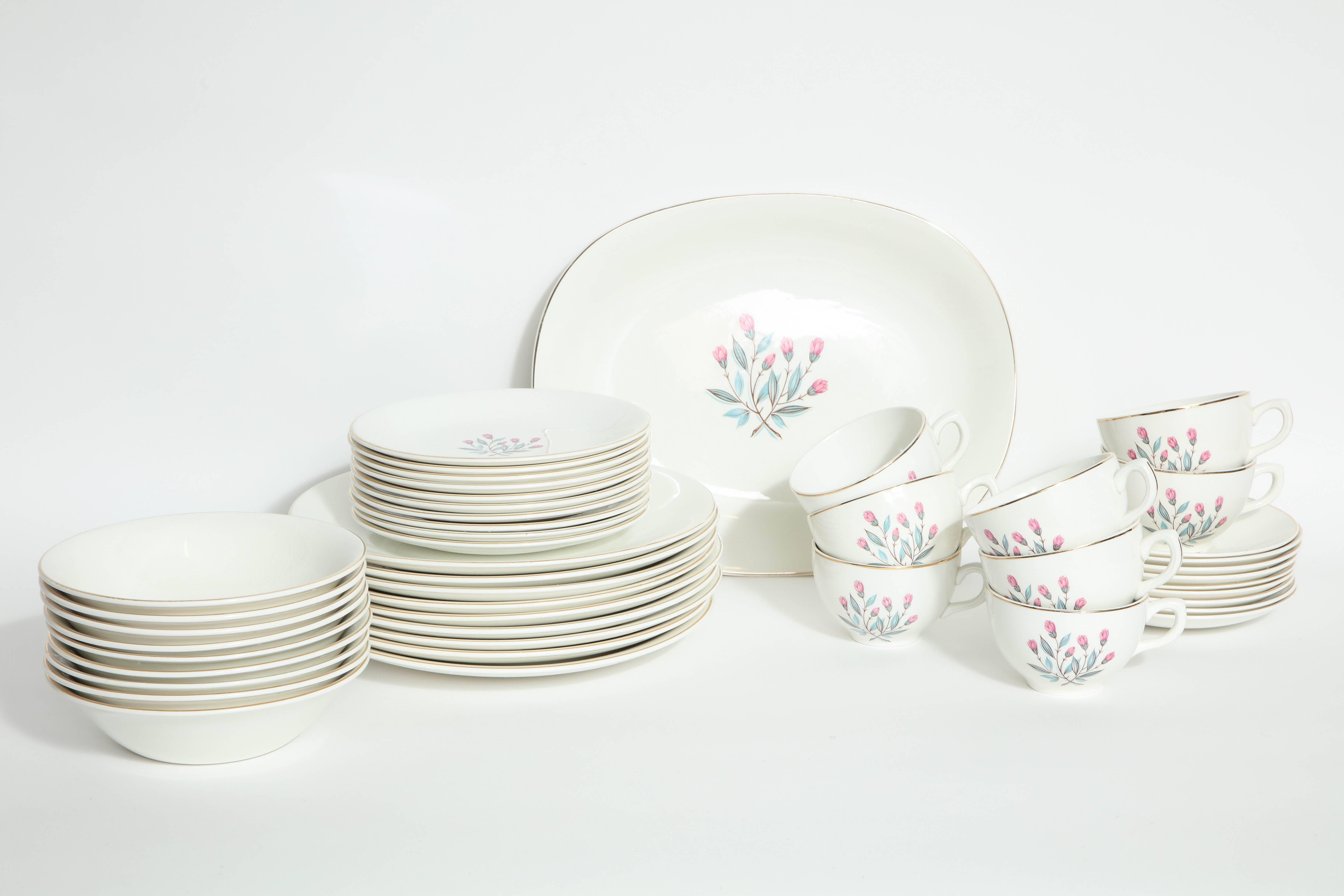 Mint condition 45 piece set of midcentury China by Wedgewood, England. Background color is bone white with stylized pink crocus flowers decoration all trimmed in gold. Mint condition, never used was in a display hutch.
Set includes:
Platter not