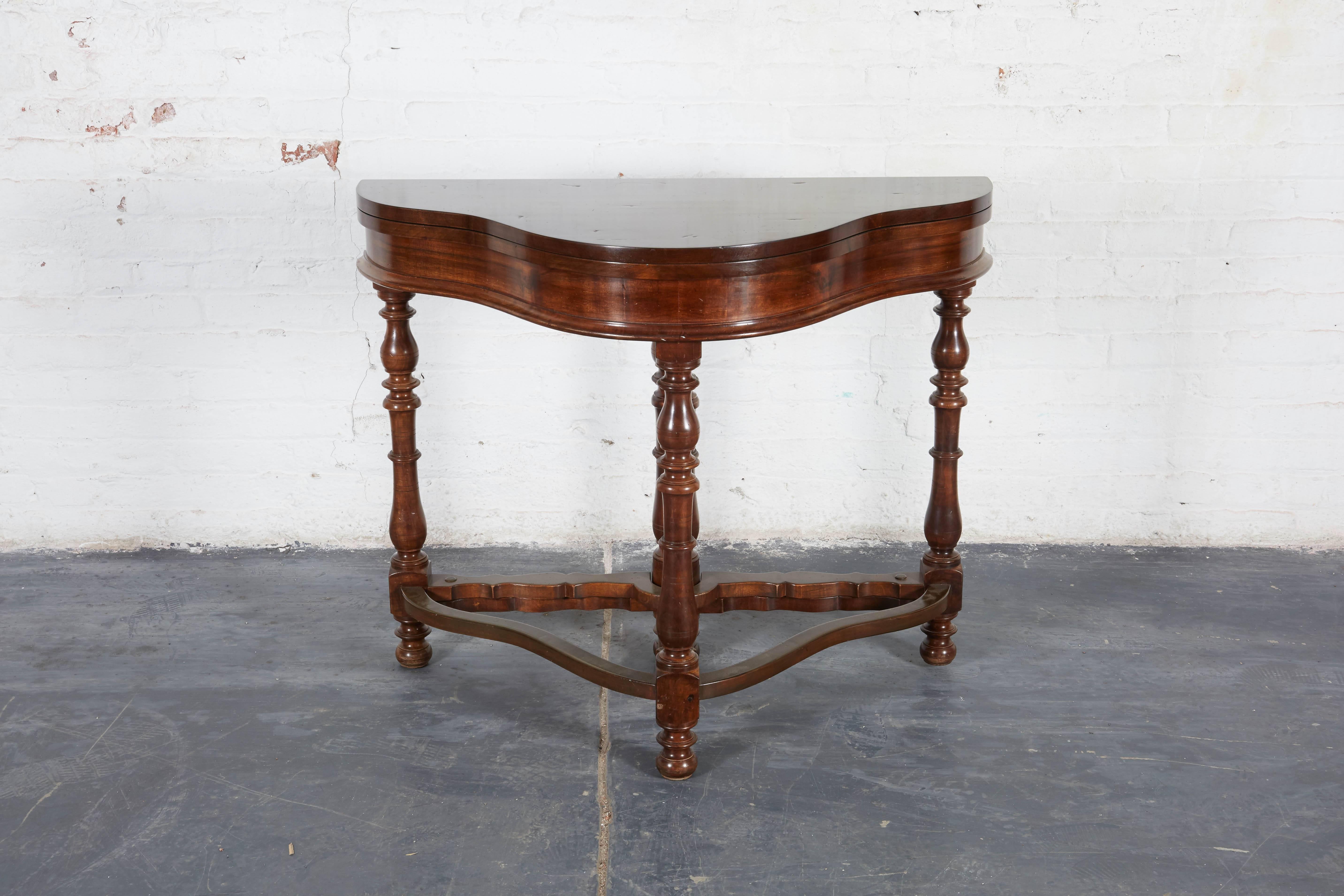 Each with shaped hinged top opening to a quatrefoil shape; raised on turned baluster form pages joined by stretchers. Lovely sculptural Silhouette and modern in its lack of embellishment.