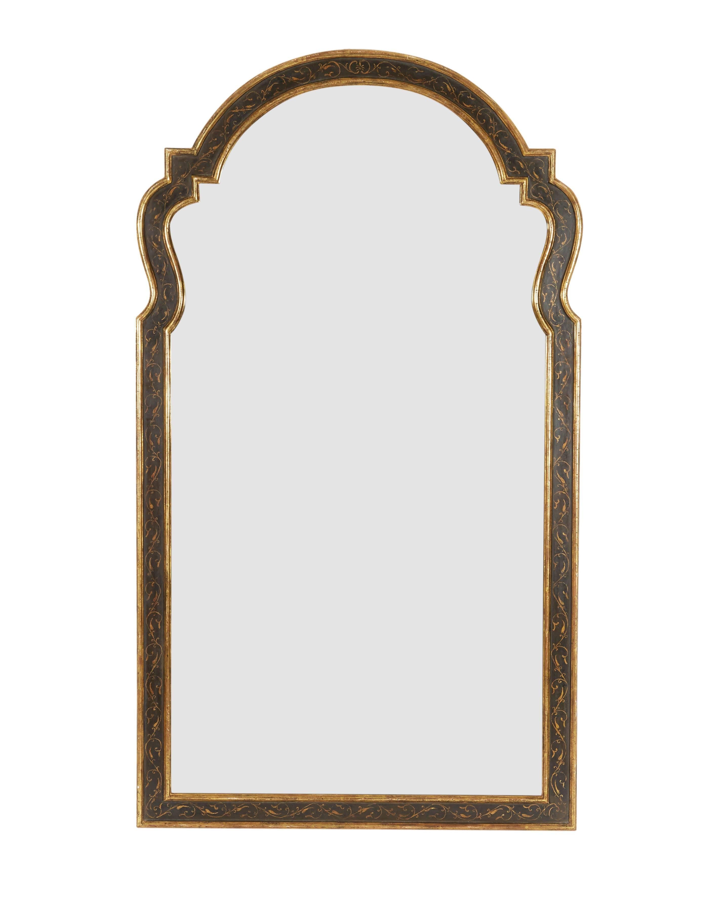 Beautifully hand-carved and painted by the celebrated frame makers House of Heydenryk. Each with arched rectangular antiqued divided mirror plate within a conforming surround with gilt rinceau decoration on a black ground with gilt edges. Bearing