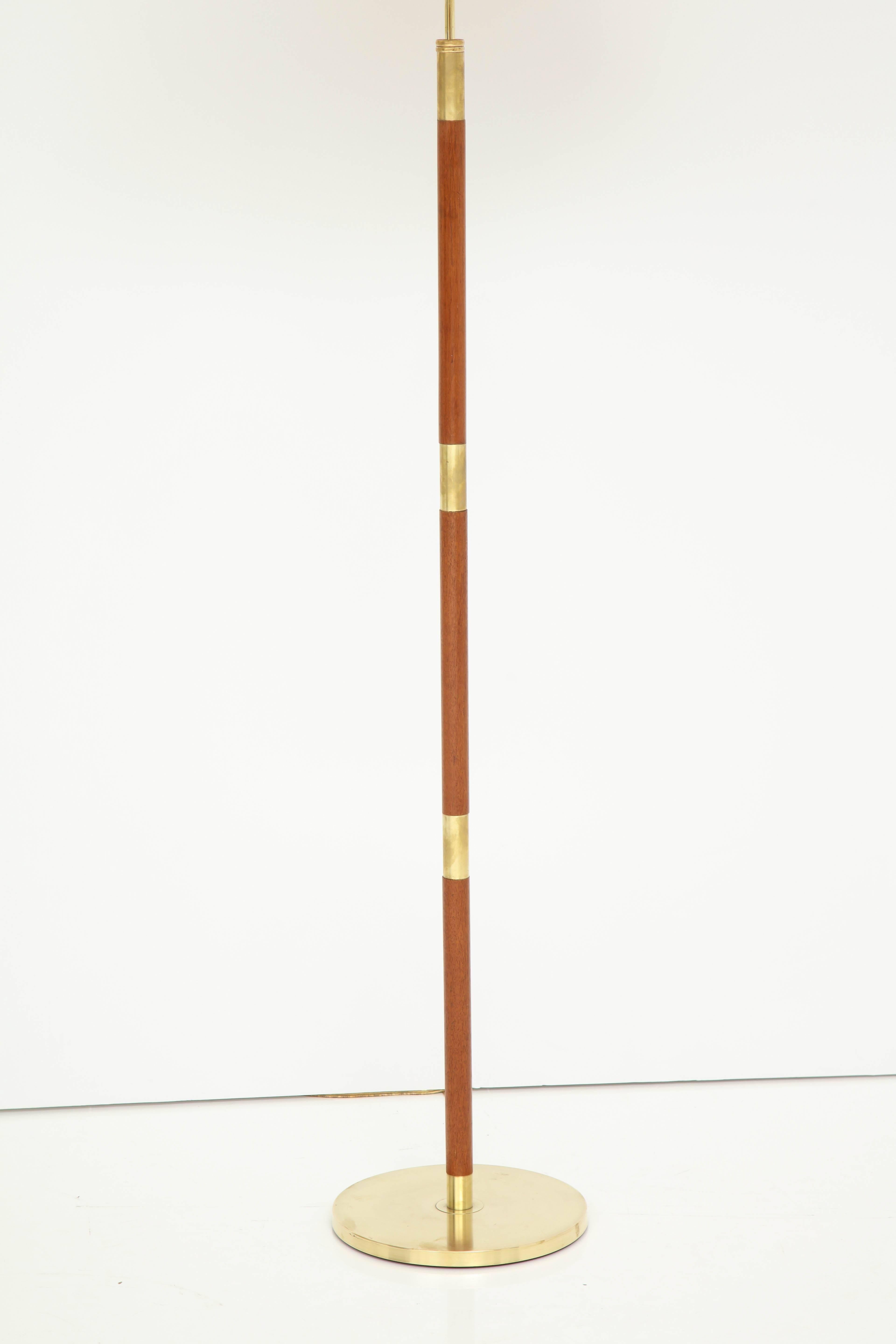 A Danish brass and teak floor lamp by Fog & Mørup, circa 1950s. Adjustable height. Re-wired for US.
 