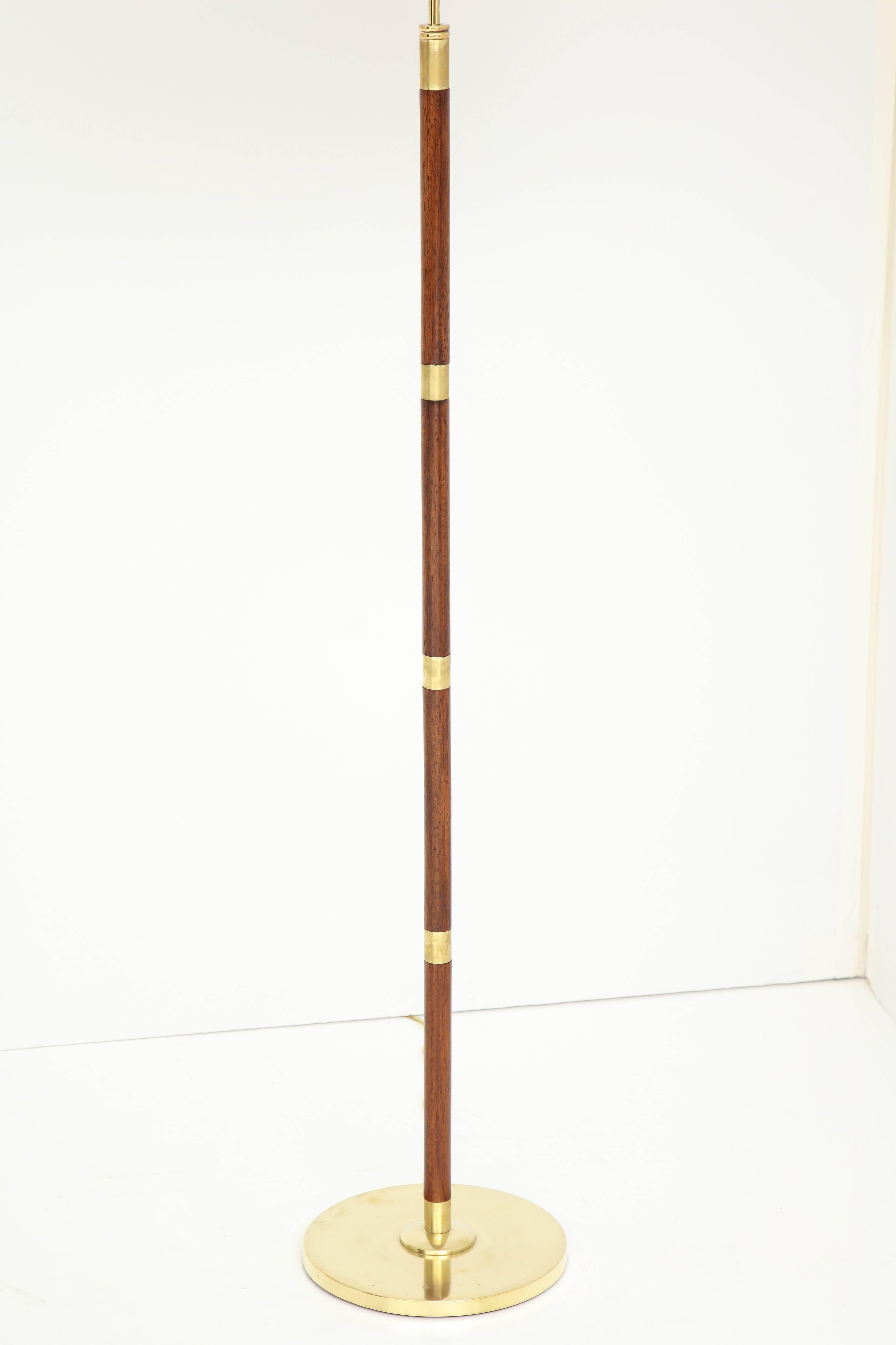 A Danish brass and teak floor lamp by Fog & Mørup, circa 1950s. Adjustable height. Re-wired for US.