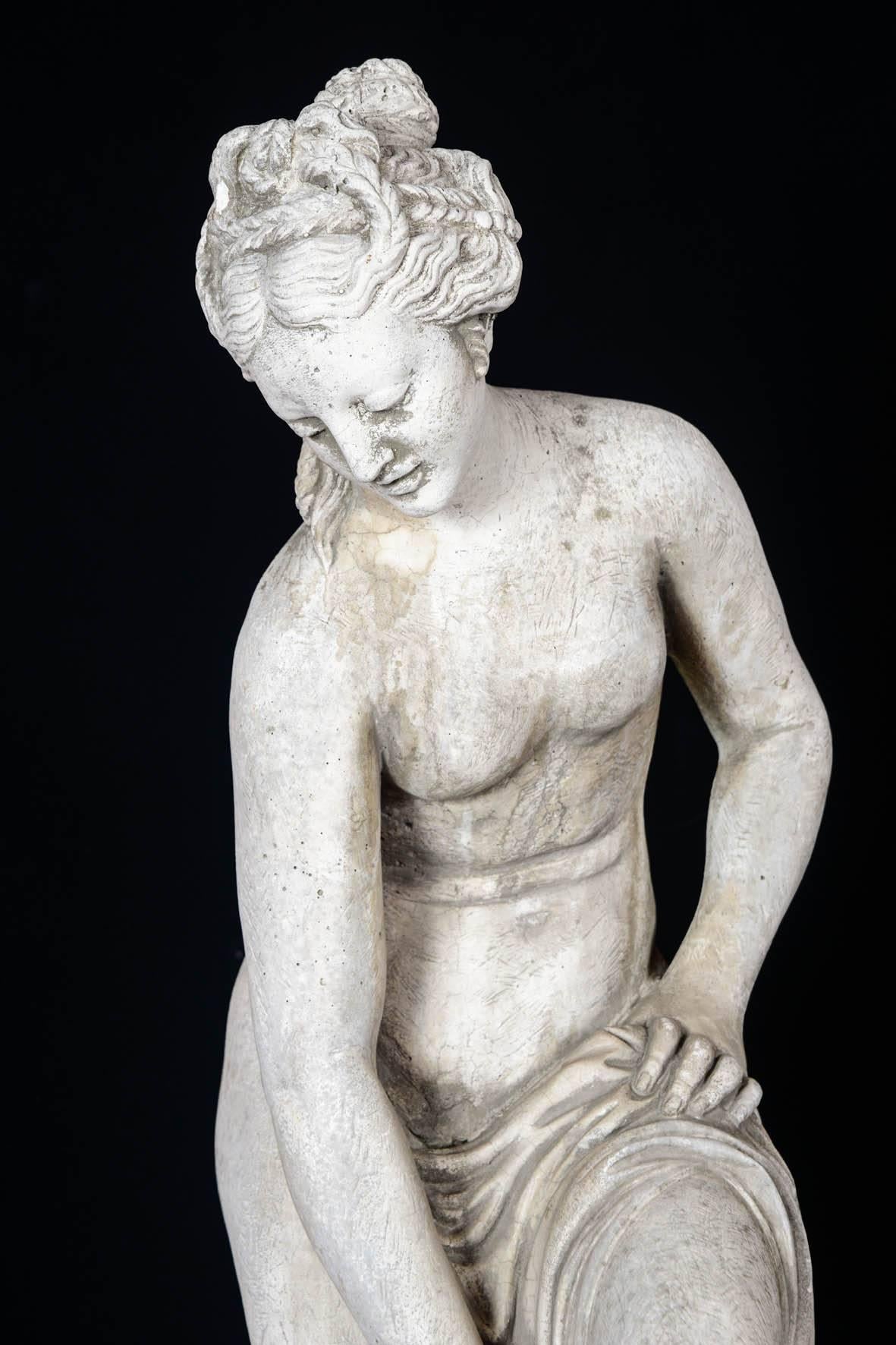 Sculpture in concrete of a bather exiting her bath, 20th century.
 