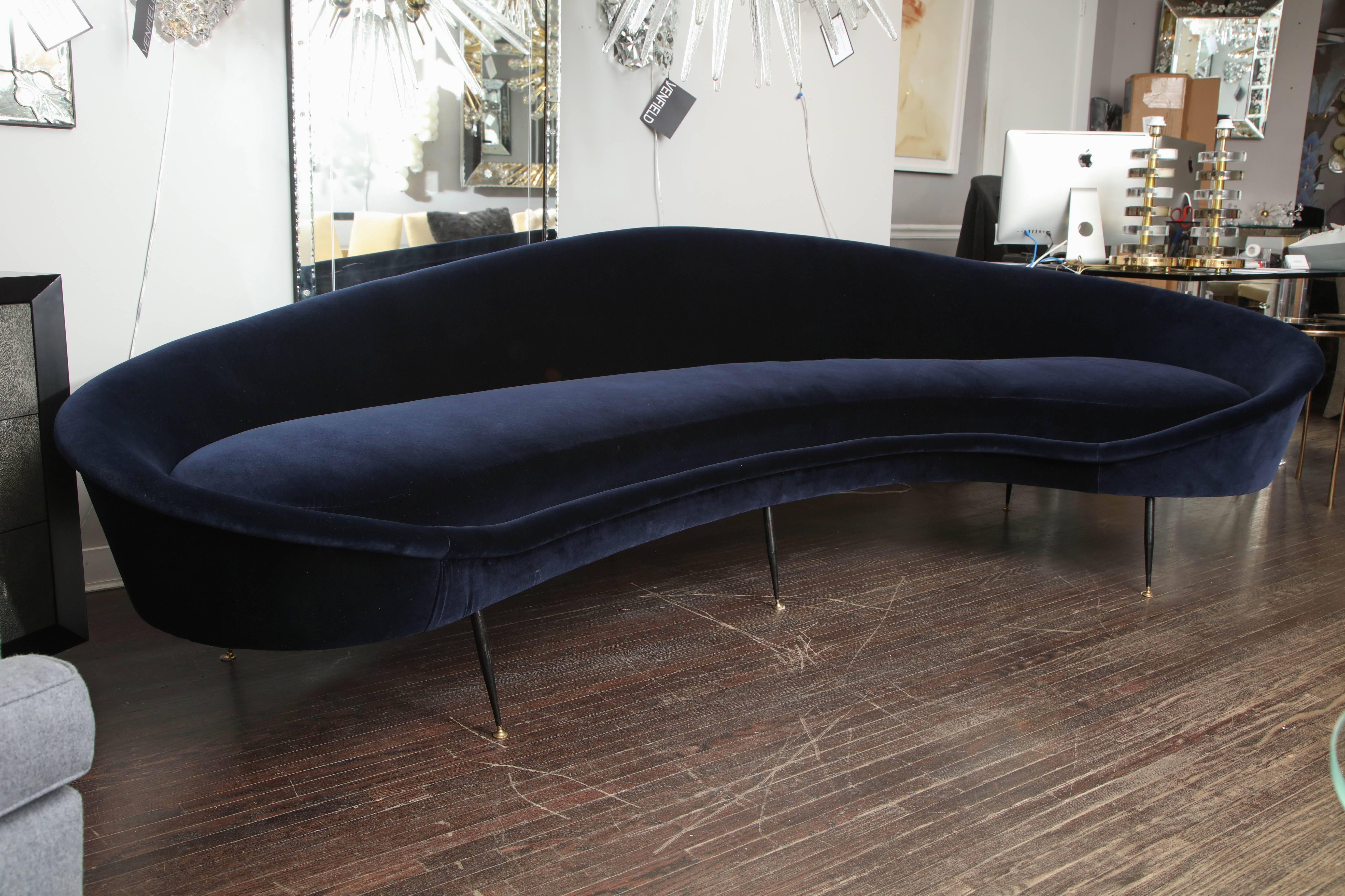 Custom curved sofa with brass legs. As shown in Navy velvet.