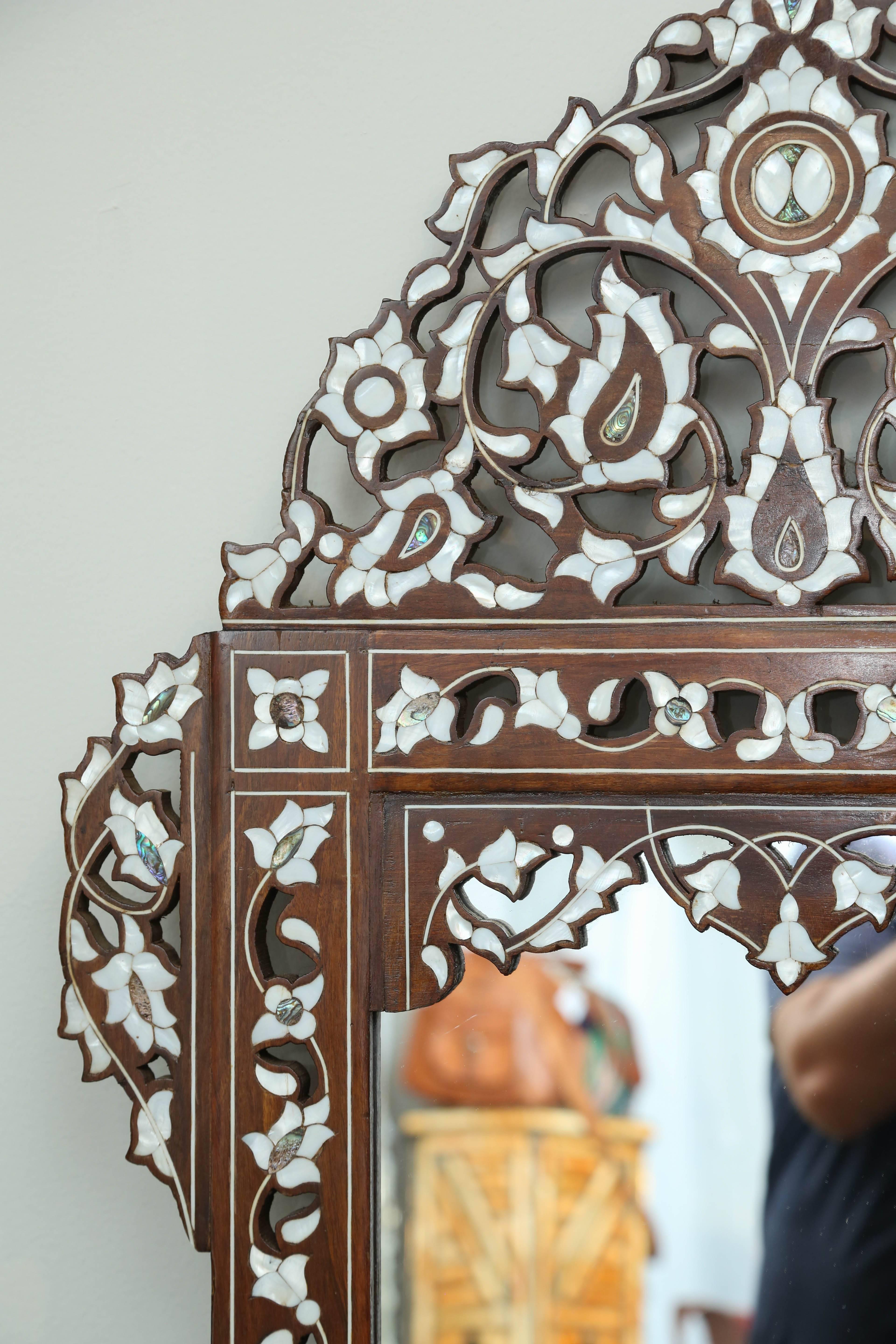 Vintage mirror circa 1970s from Syria with gorgeous mother-of-pearl detailing.
        