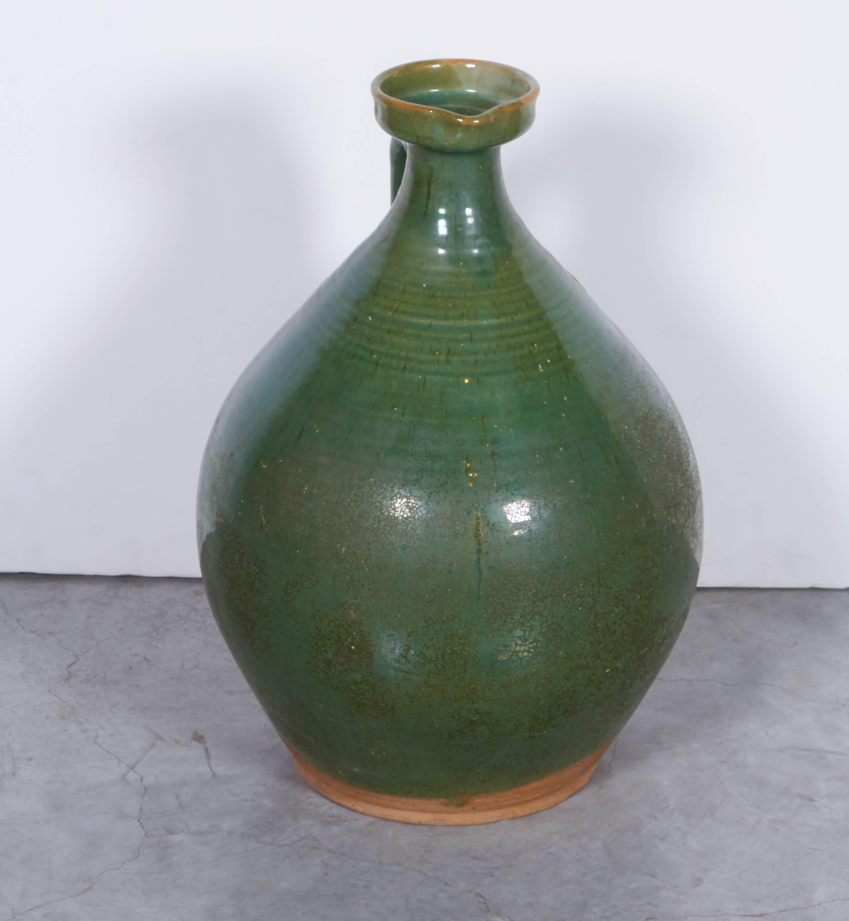 A large and gracefully shaped antique Chinese ceramic wine jar from Yunnan Province with beautiful green glaze. 
CR469.

