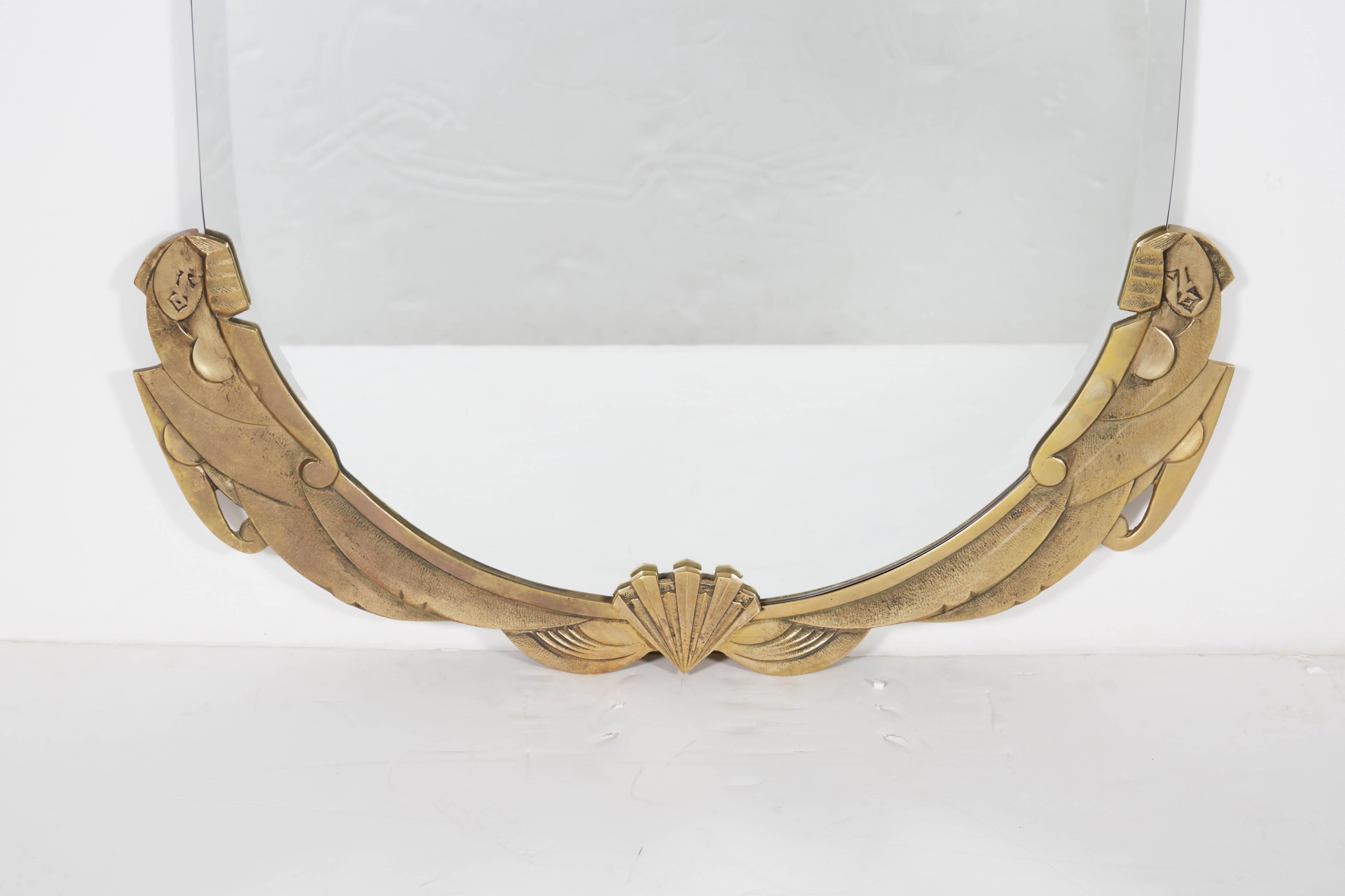 French Art Deco bevelled glass mirror with truncated top depicting a stylized nude woman flanking either side of the bronze surround.
This mirror can be used in a bathroom, hallway, bedroom, over a fireplace mantel, console.
The bronze frame can