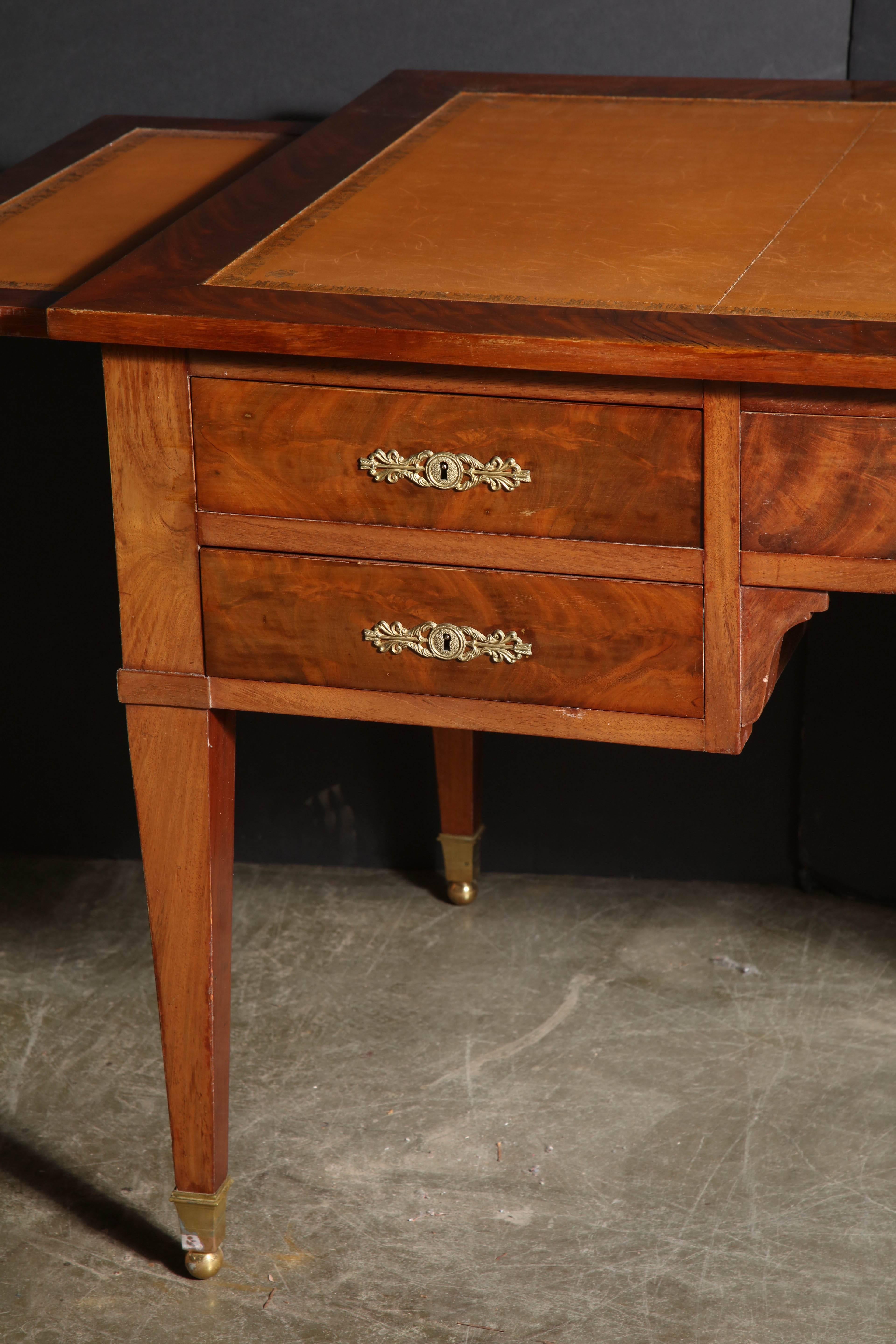 Fine French neoclassic mahogany leather top bureau plat with double slides, brass ball sabots, bronze escutcheons and a fitted double drawer.