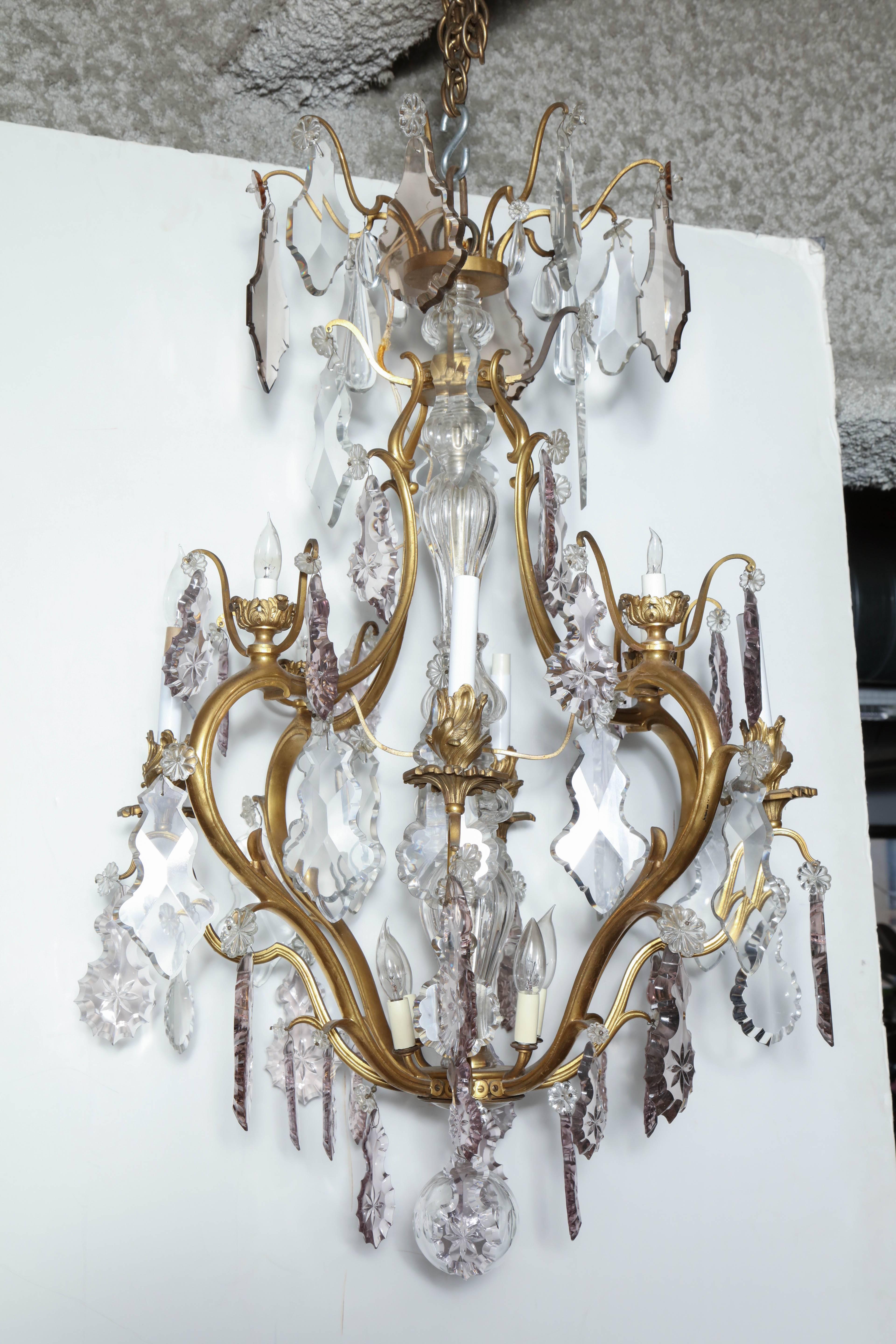 Louis XV bronze and crystal 12 lite multi-tier chandelier with large shaped crystals and scroll form arms.