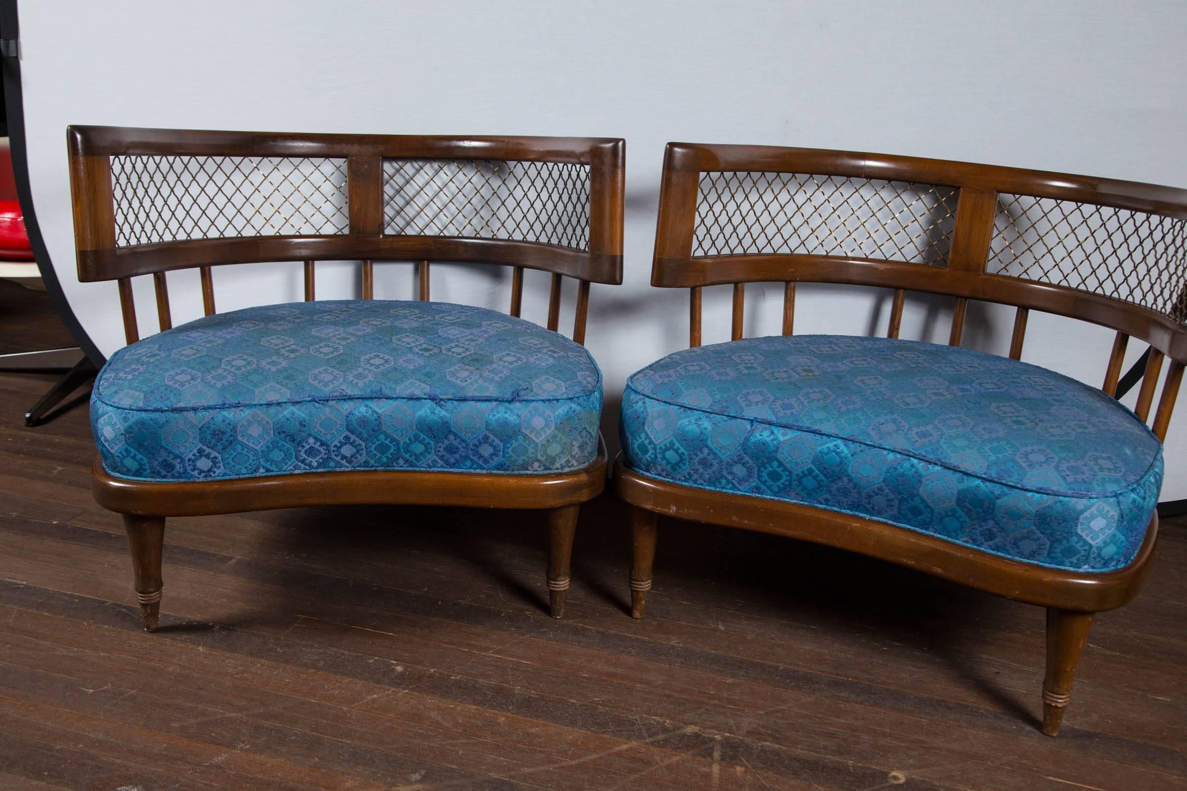 Low stylish lounge chairs in the style of Billy Haines. Mid-Century Modern curved back wood chairs. Bronze metal lattice detail below curved crest rail.