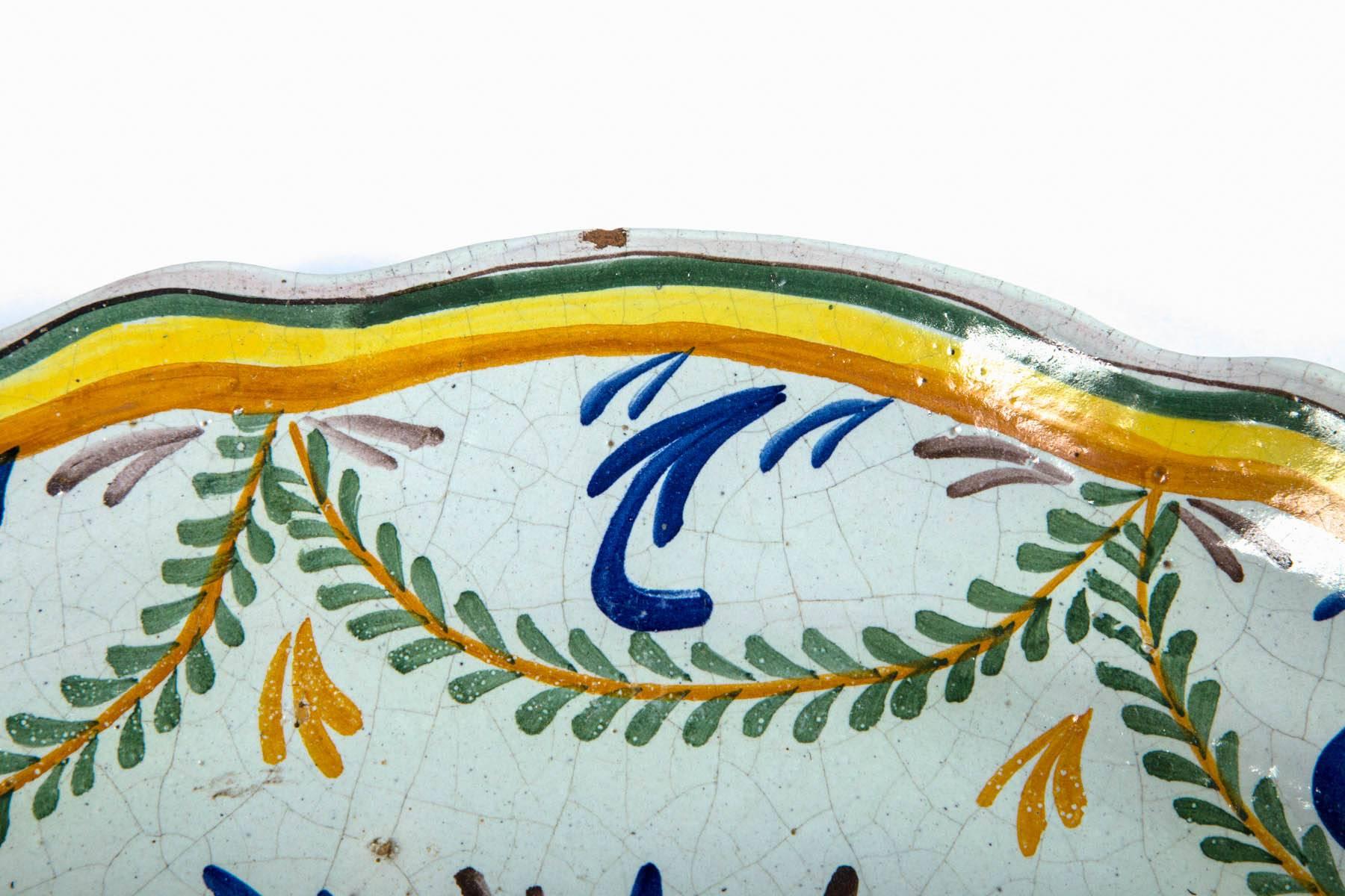 French faience platter, late 19th century. Wonderful hand-painted design in traditional French blue, yellow and green glazes. Oval shape with scallop edge.