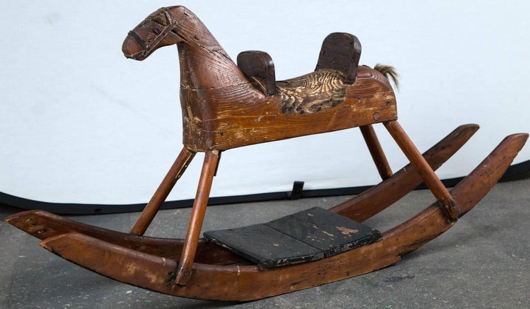 Child's rocking horse, circa 1900. Carved wood, original finish. A wonderful piece of American Folk Art. Provenance: du Pont Family.