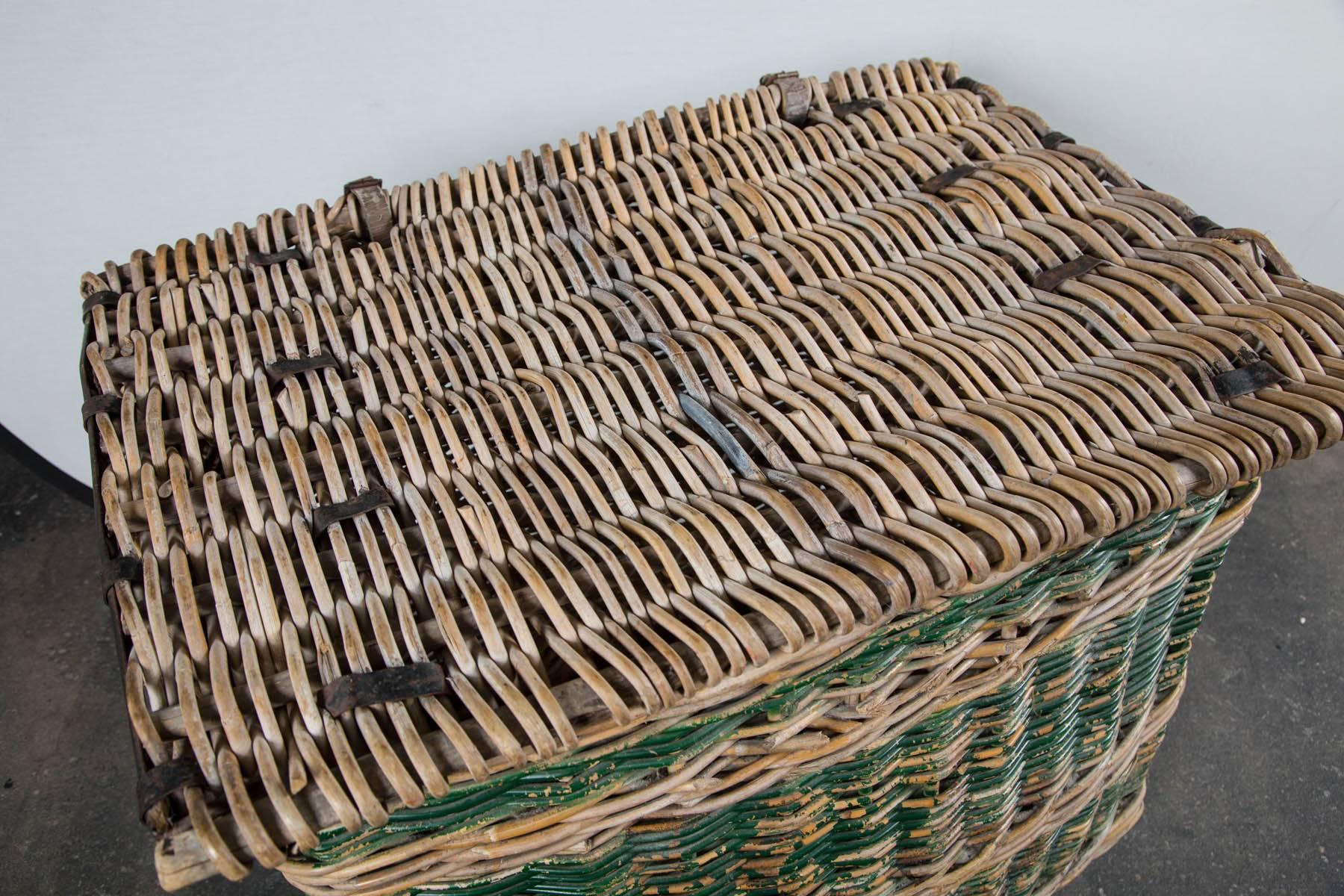 French woven rattan lidded basket with handles, circa 1920s. Grand size storage basket or trunk. Original paint, leather straps and iron hardware.