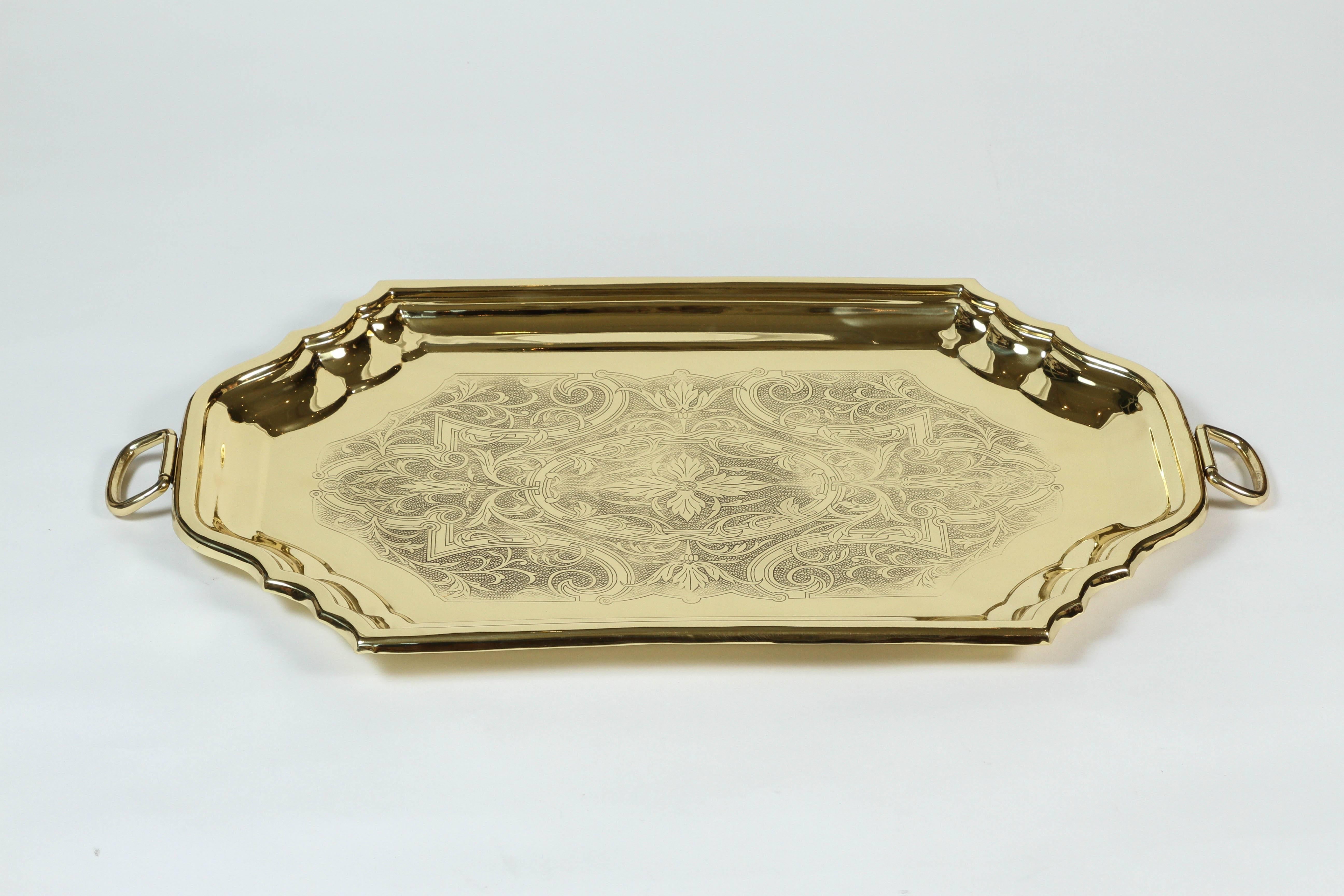 Newly polished vintage brass serving tray with engraved floral design and handles.