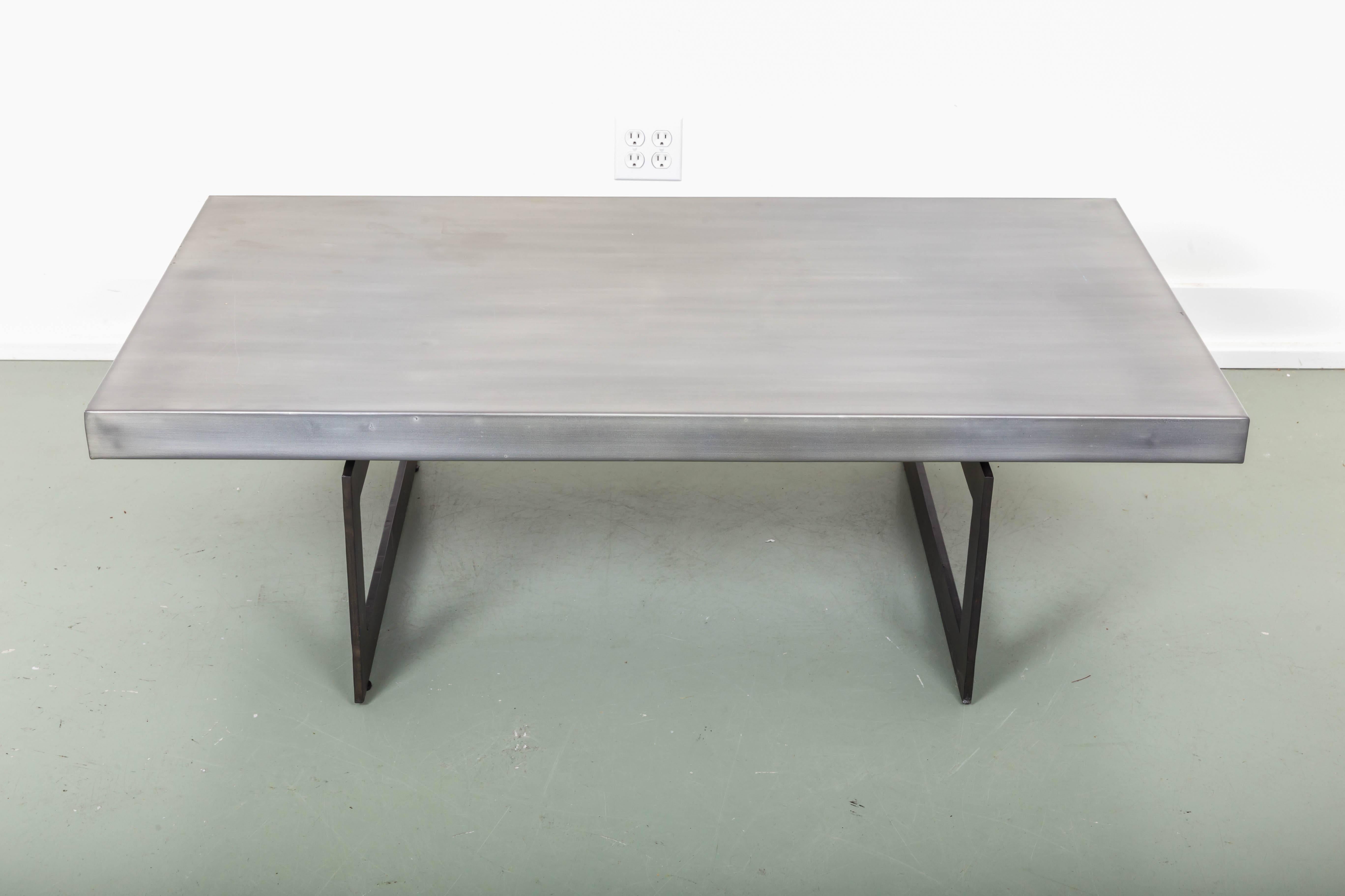 Steel and bronze coffee table. Brushed steel top supported by bronze picture frame style legs.