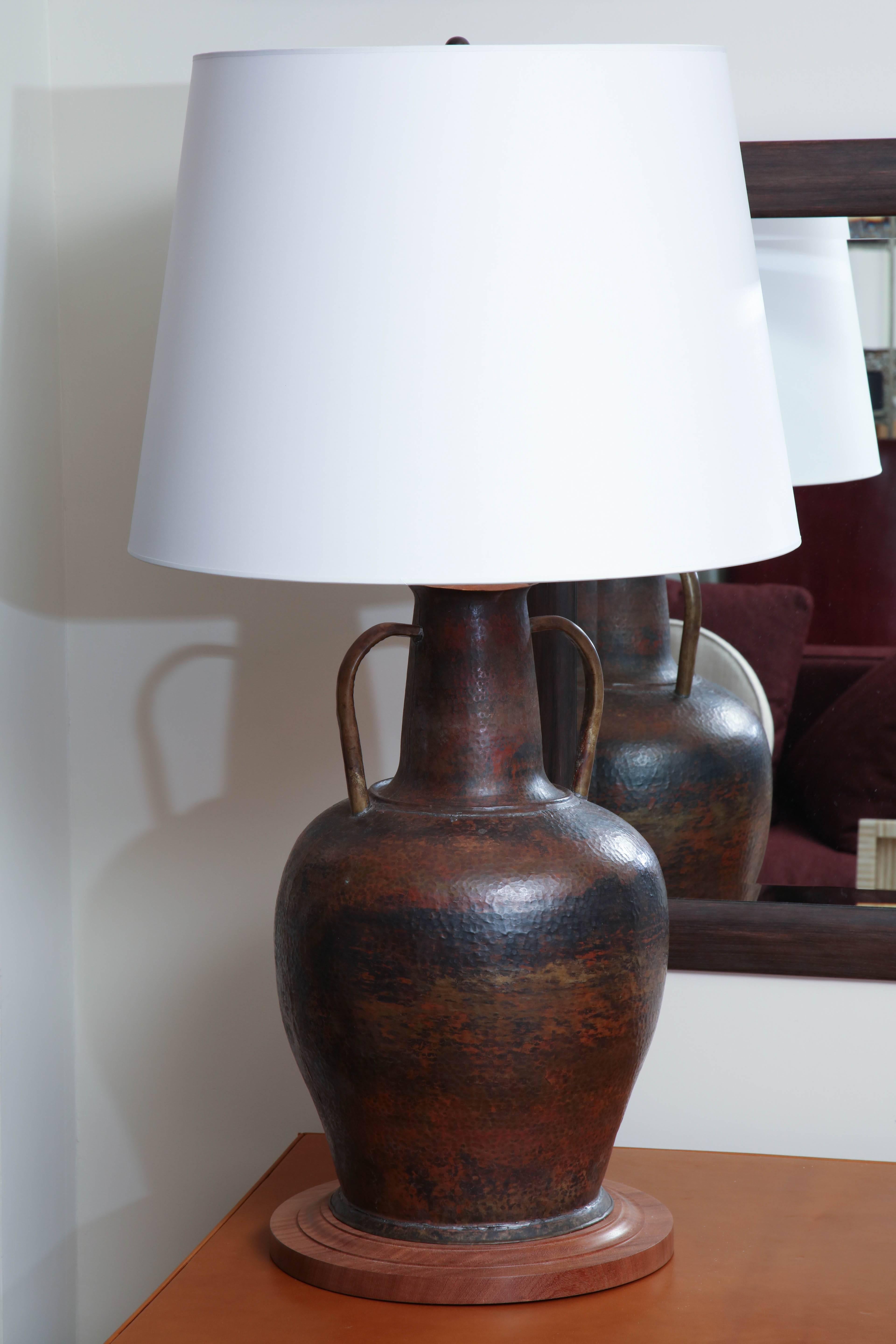 Hand-formed copper two-handled vessel from Morocco transformed into a table lamp. Turned walnut base, circa 1950.