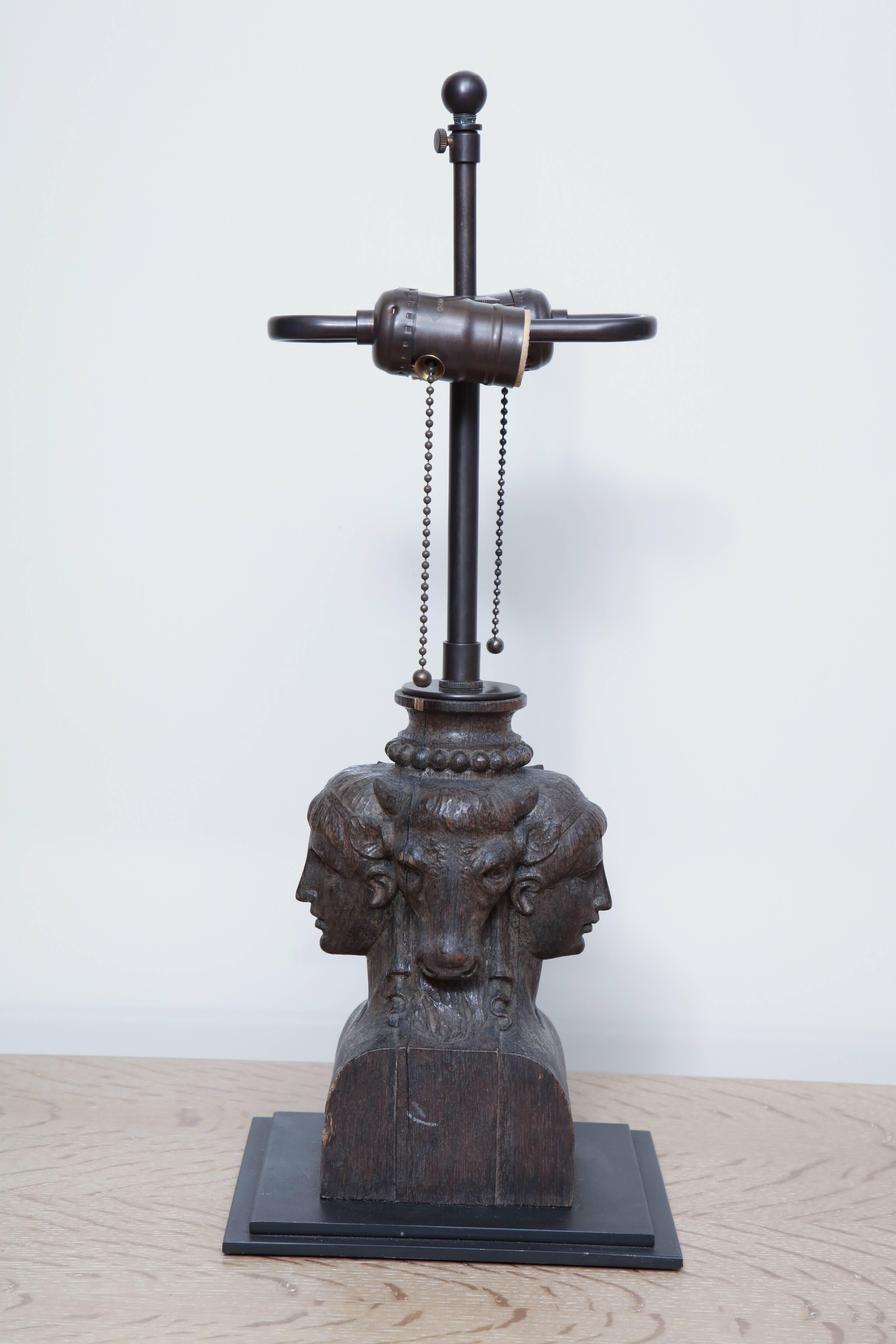 Table lamp converted from a hand-carved oak architectural element with mythological elements and stepped base, circa 1920.