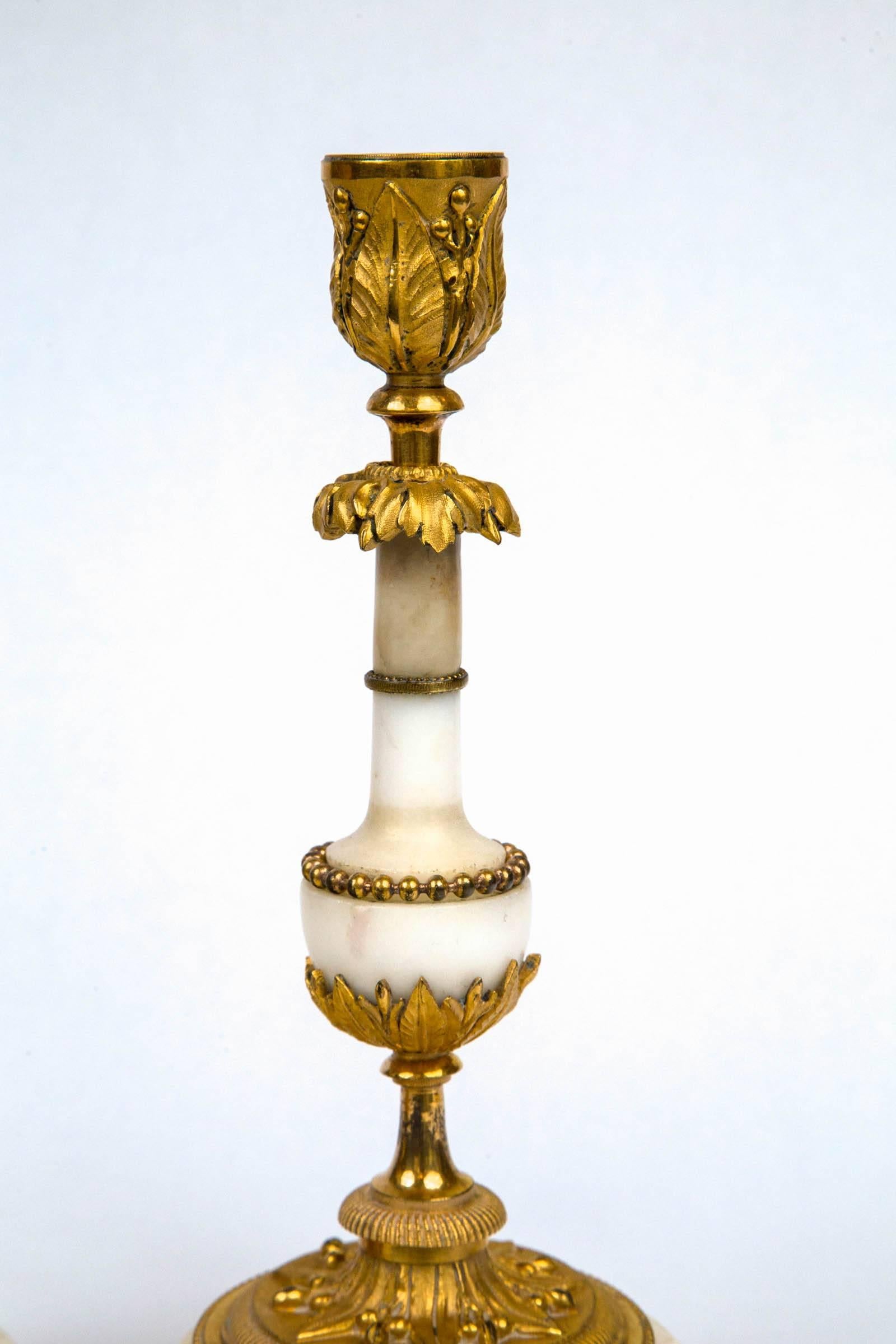 Fine white marble with fire gilt bronze mounts. Three ball feet and a brace underneath.
 