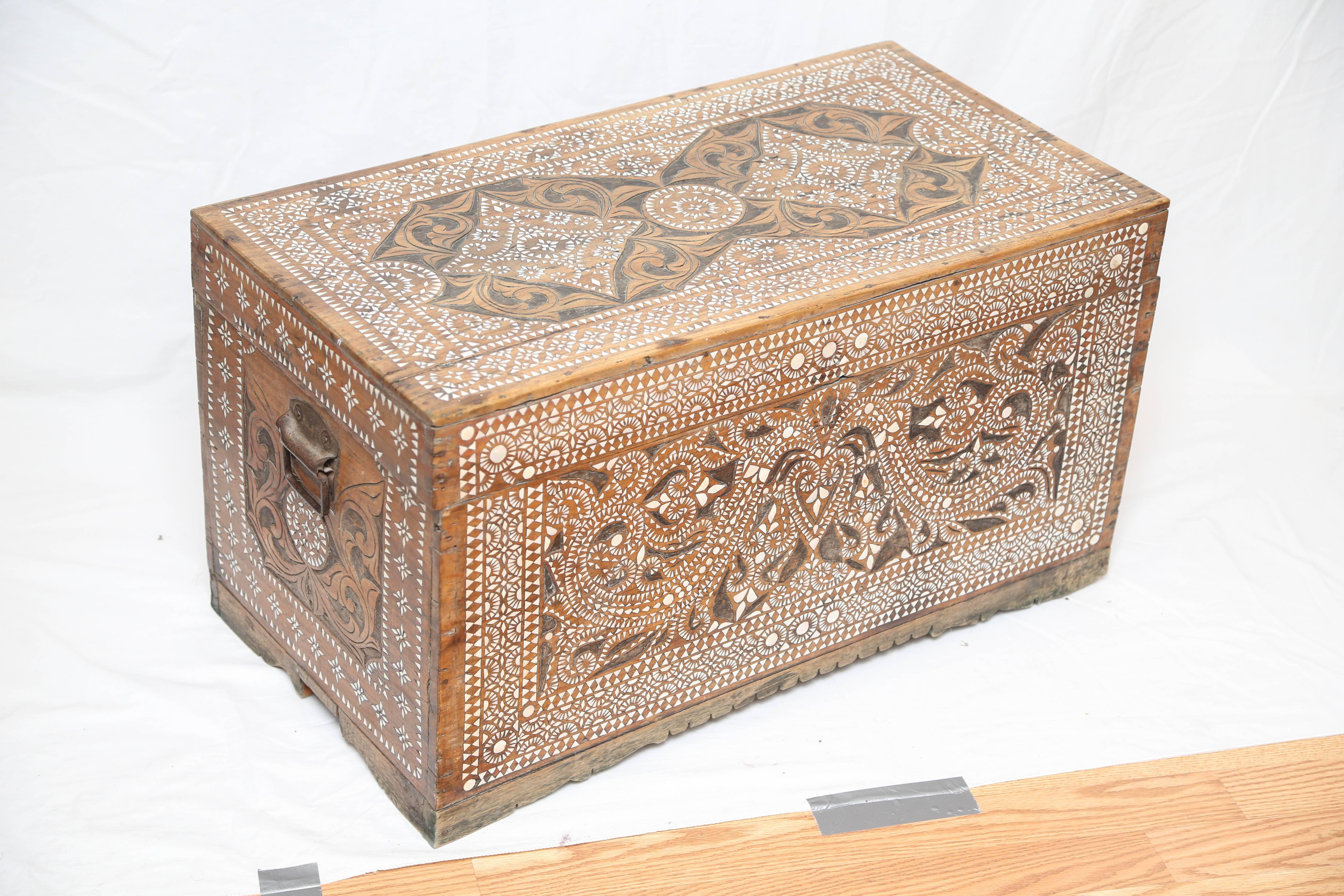 Beautifully carved and detailed Syrian trunk from the late 19th century. Intricate design with inlaid mother-of-pearl.