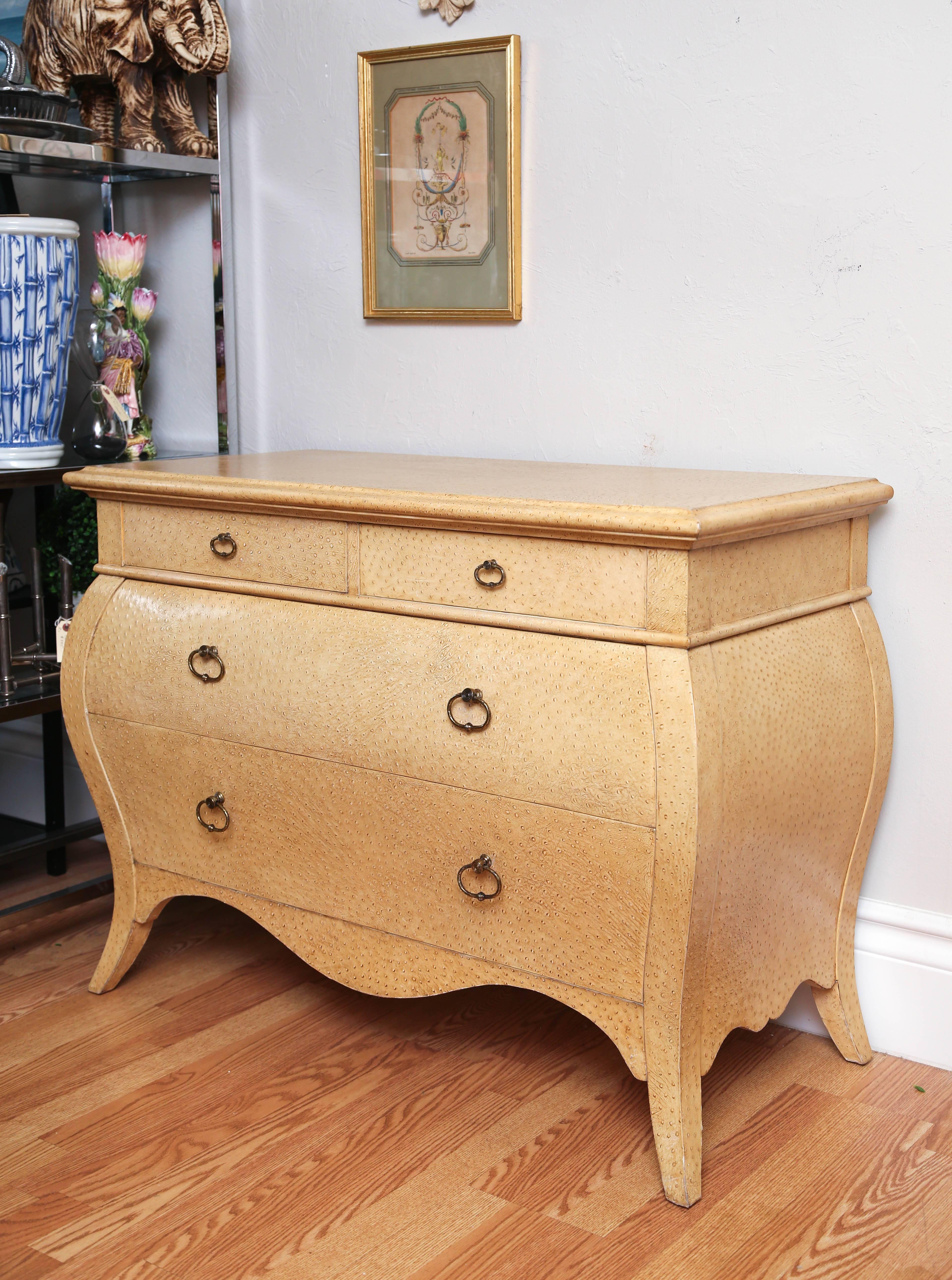 Striking four-drawer Bombay commode covered in faux ostrich skin with brass pulls.