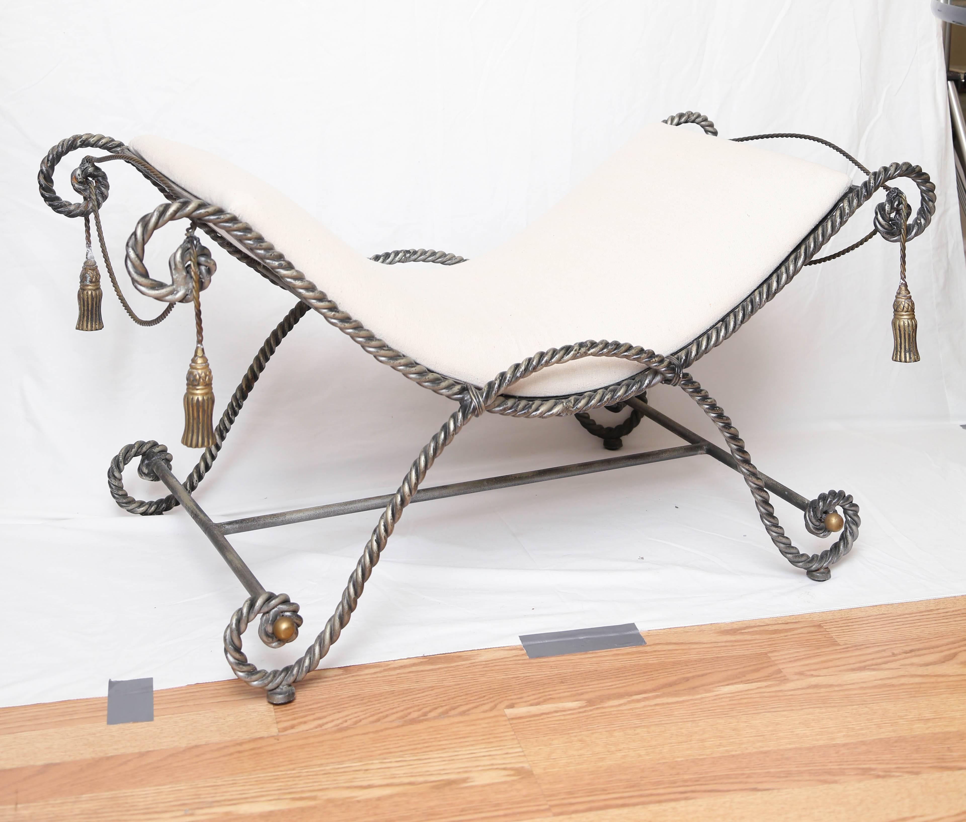 Gilded rope and tassel iron Curule style bench.