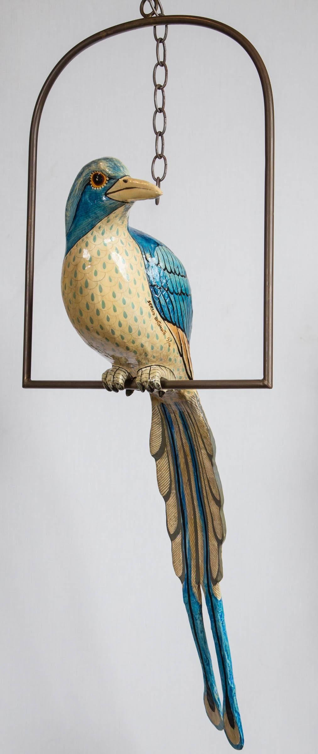 Colorful papier mâché bird on a brass swing by Sergio Bustamante.
Signed and marked 19/100.