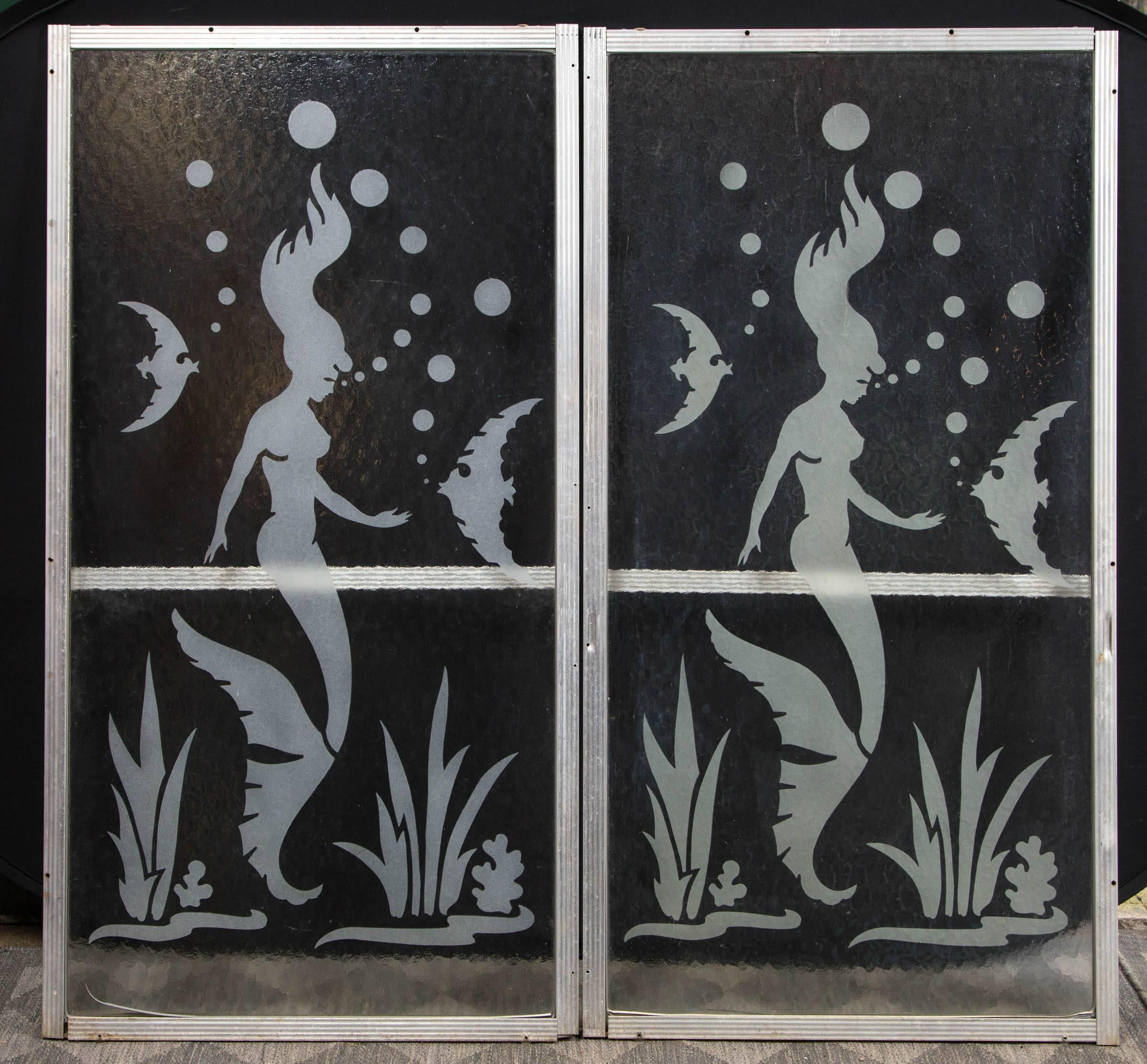 Fabulous mermaid images on a pair of glass panels. The dimensions given are for one glass panel
minus the aluminum frame. Aluminum frames are 1.25 inches wide. Hammered finish on glass.