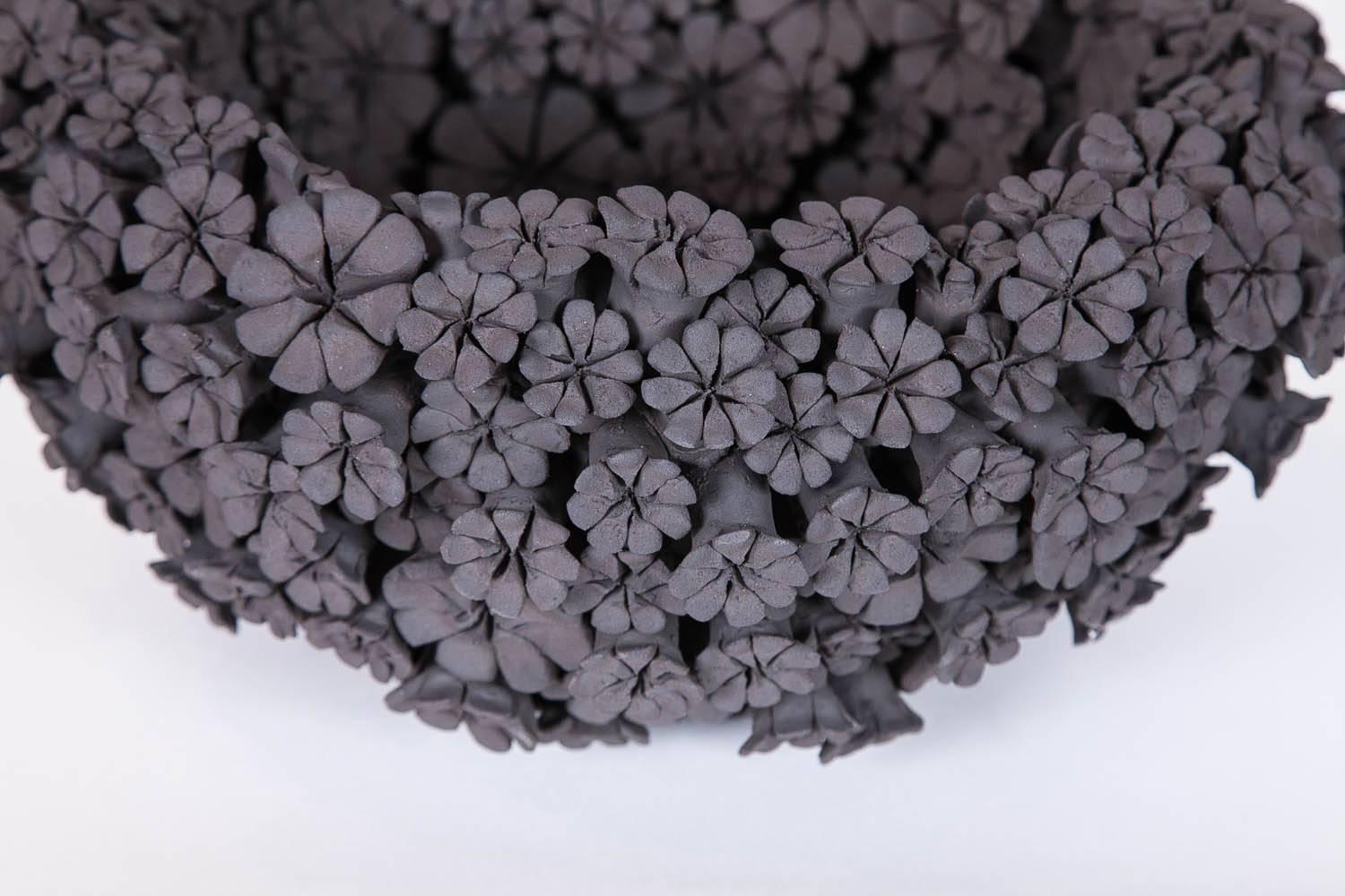 The Marigold bowl is a unique hand-sculpted black stoneware centrepiece completely covered in a multitude of individually made flowers created by the British artist Vanessa Hogge.

Vanessa Hogge breathes life into her clay in the form of dahlias,