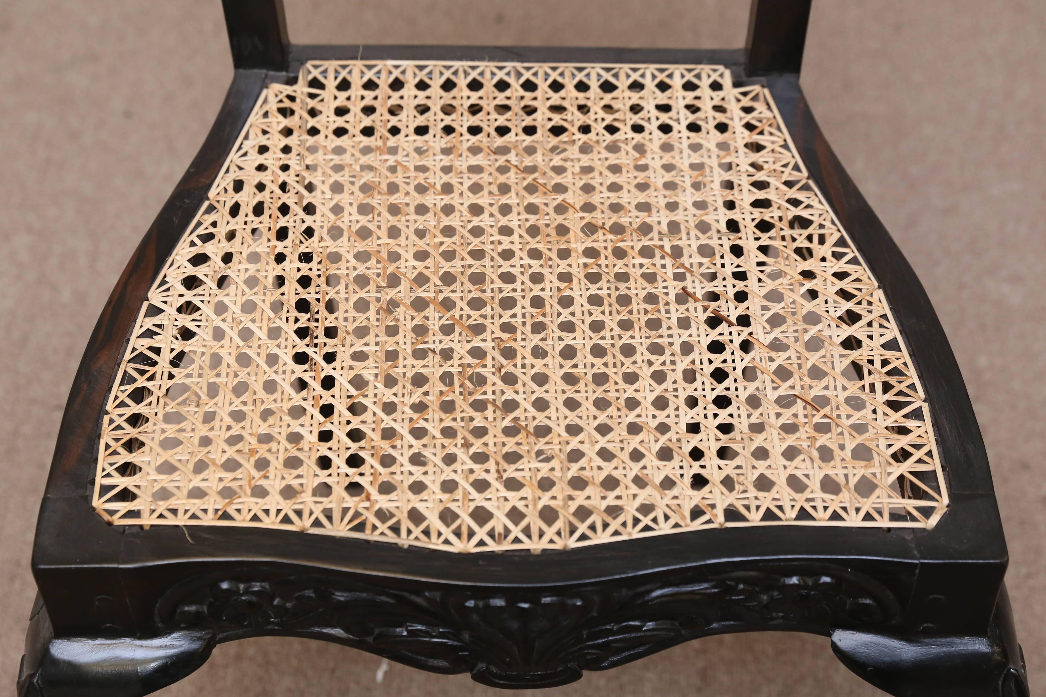 Sri Lankan Four Mid-19th Century Exquisitely Carved Solid Ebony and Cane Side Chairs For Sale