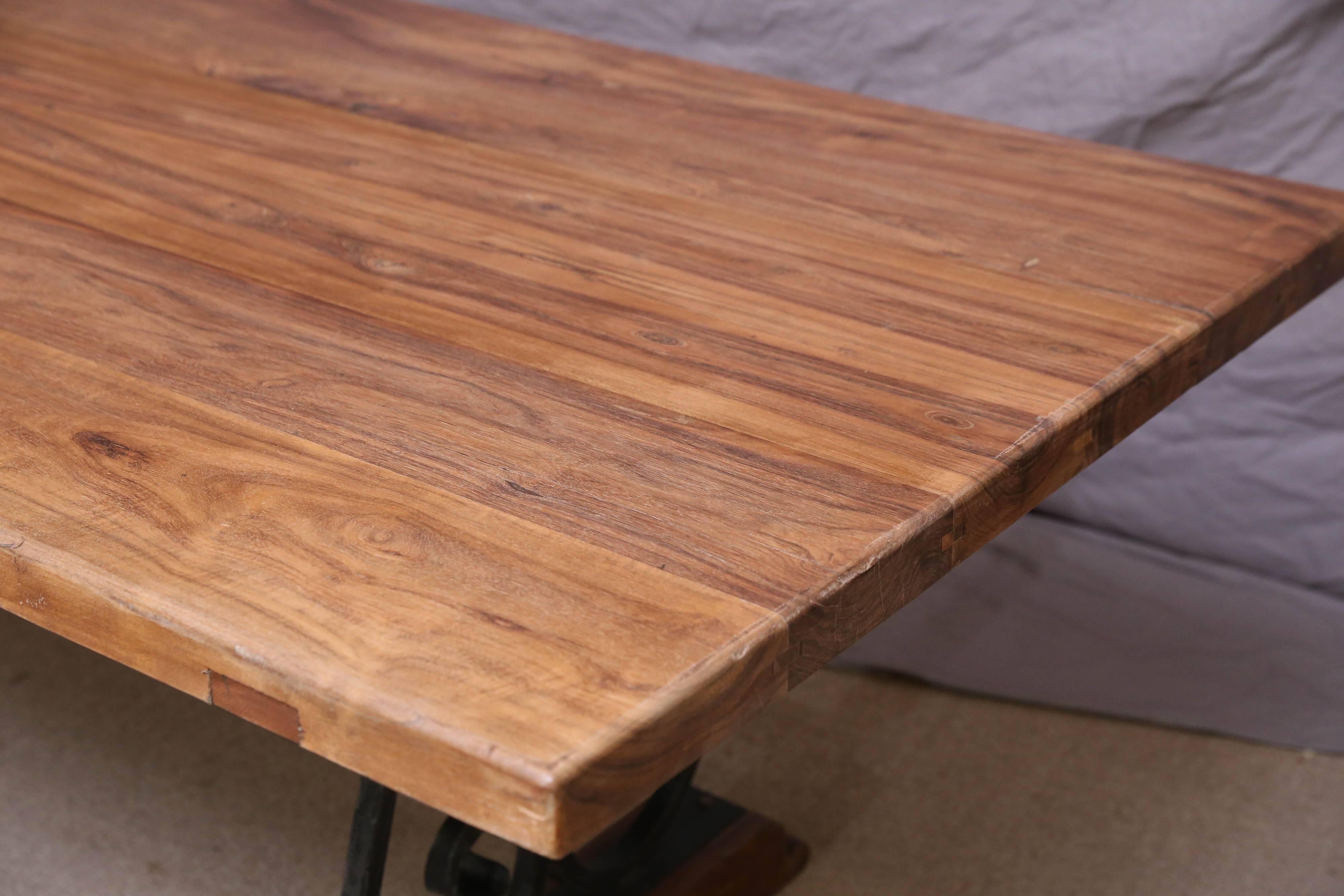 The solid teak wood top comes from a 1920s Dutch colonial farm and the iron base is recently made. The whole top is solid and thick. Note the patina and the fine grain flow on the table top.Finest teak wood was used for the top. To avoid damage to