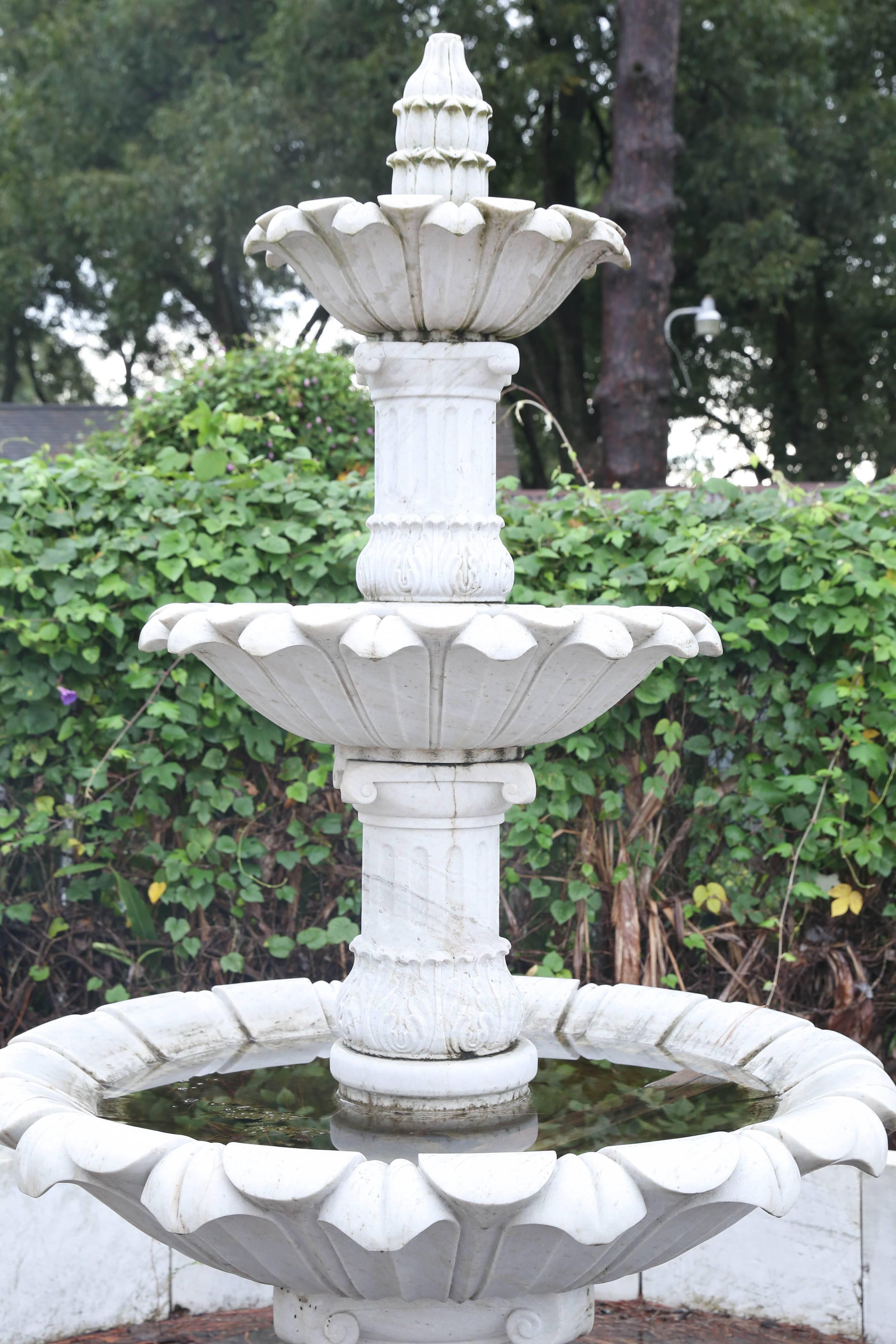 This 1950s pure white marble fountain with surround was intricately hand-carved for a park in India. Each tier is separated by a carved marble circular stem. The surround is made of marble balustrades and large scalloped shells.