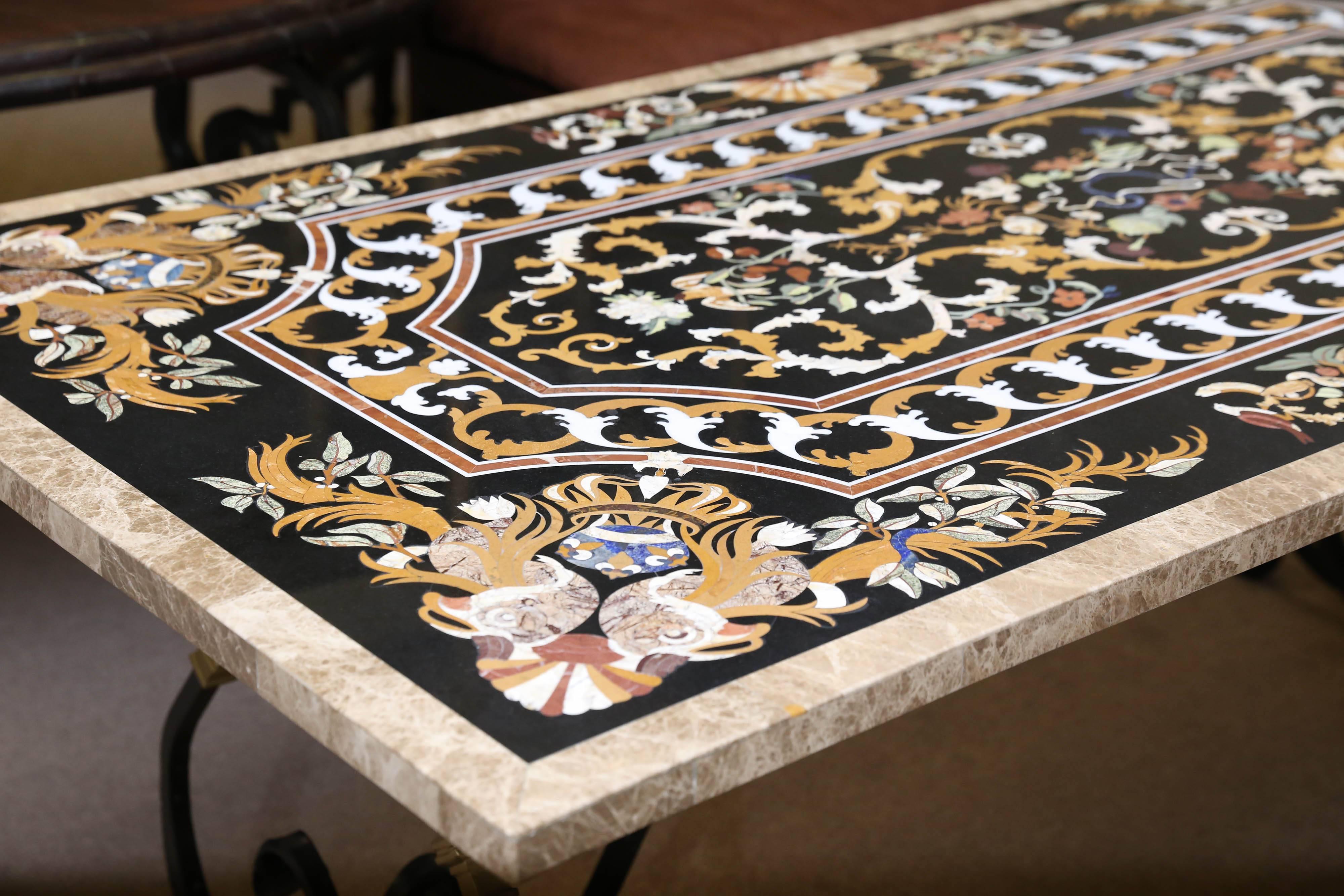 This heavily inlaid breakfast table is supported by hand-forged wrought iron base. The surface is scratch resistant as hard stones were used for inlay. Intricately inlaid with rare marbles and hard stones.