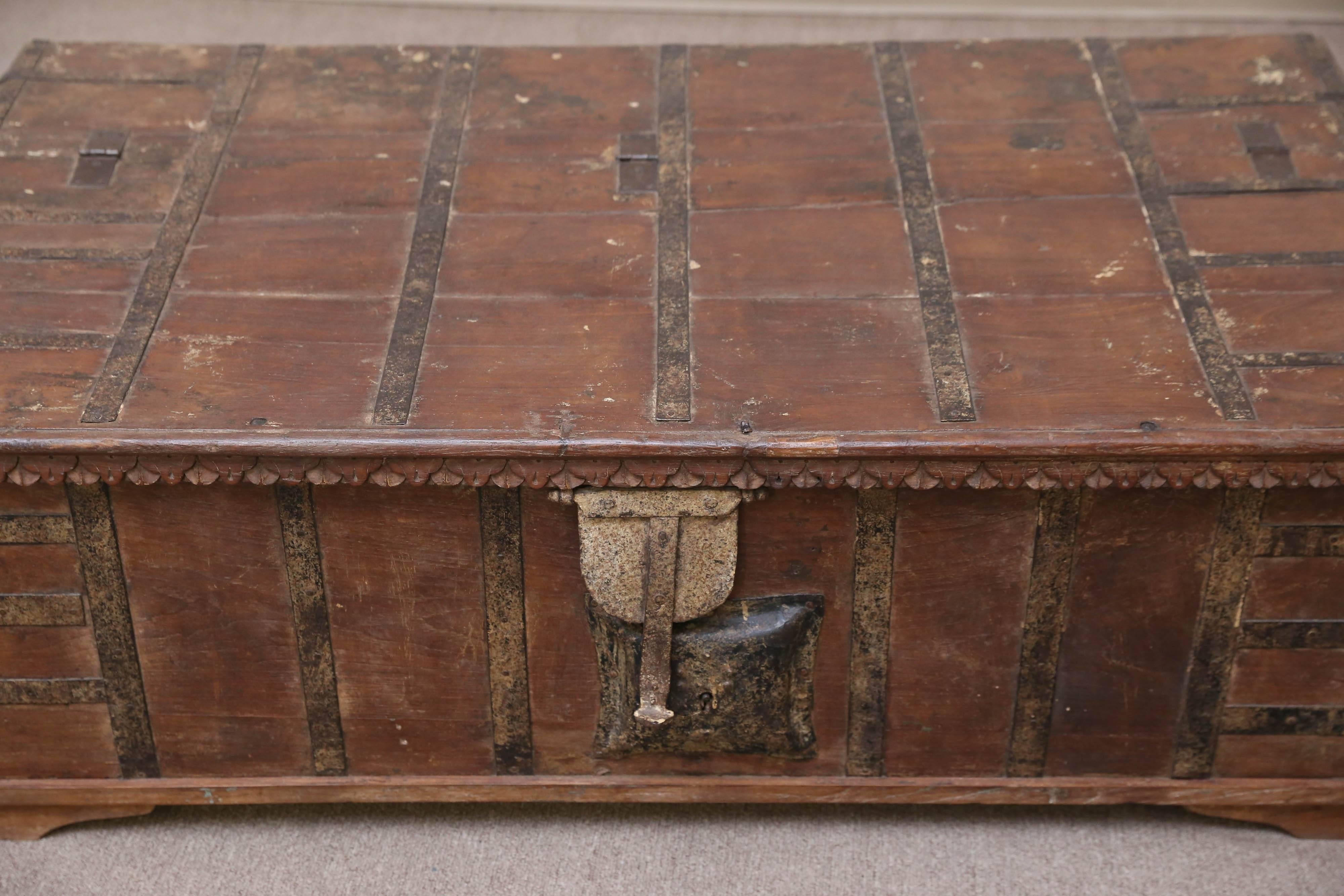 A somewhat modified teak wood dowry chest from a wealthy landlord’s home in central India. The chest is reinforced with iron bars. It retains the original mechanical (not working) lock and the lifting handles. All metal works are hand-forged. The