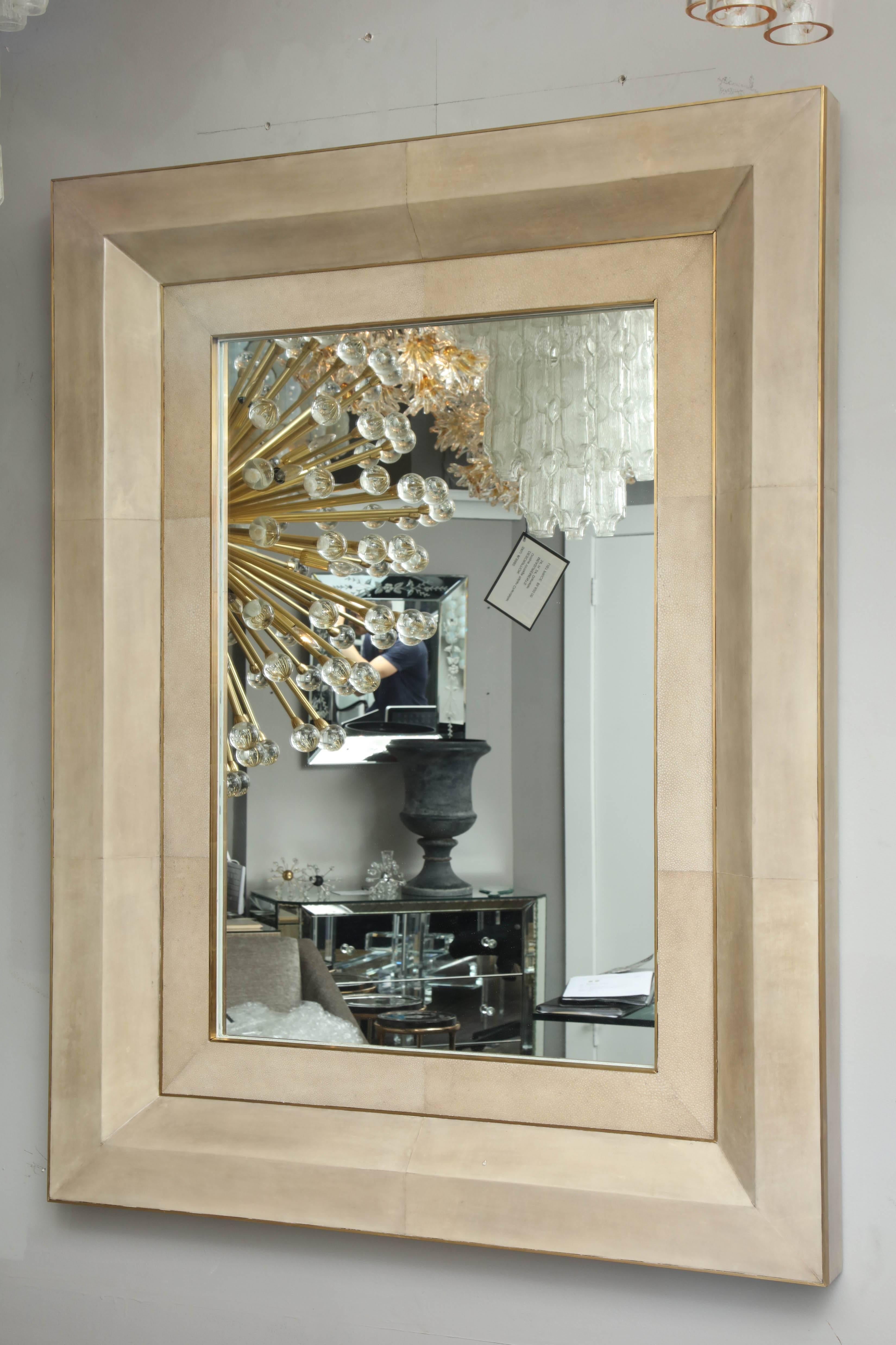 Chic goatskin mirror with brass trim. Customization is available in different sizes, trim finish and parchment colors.