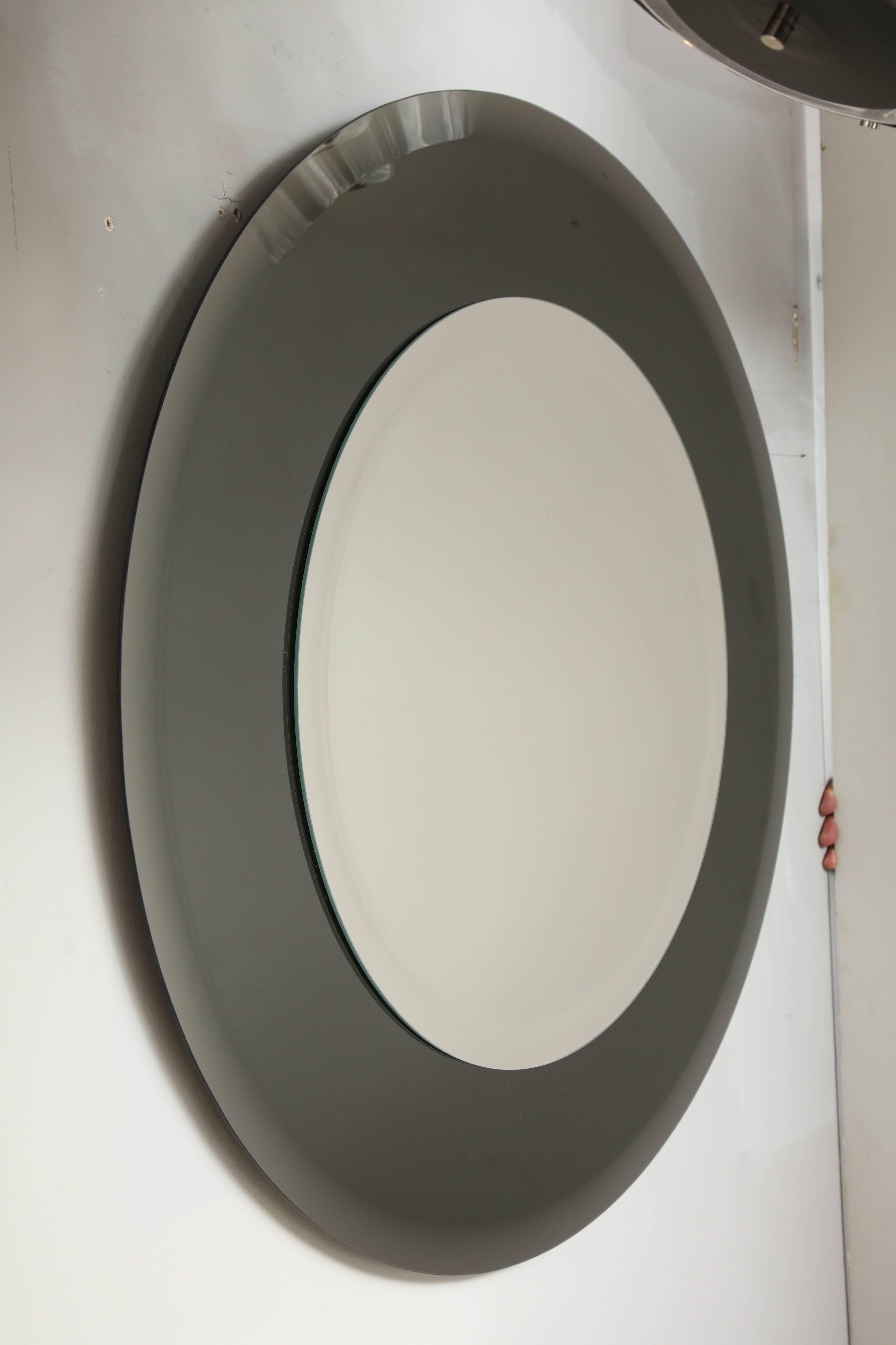 Miroir rond à bord biseauté sur mesure avec bordure en verre fumé. Le miroir au centre fait 22