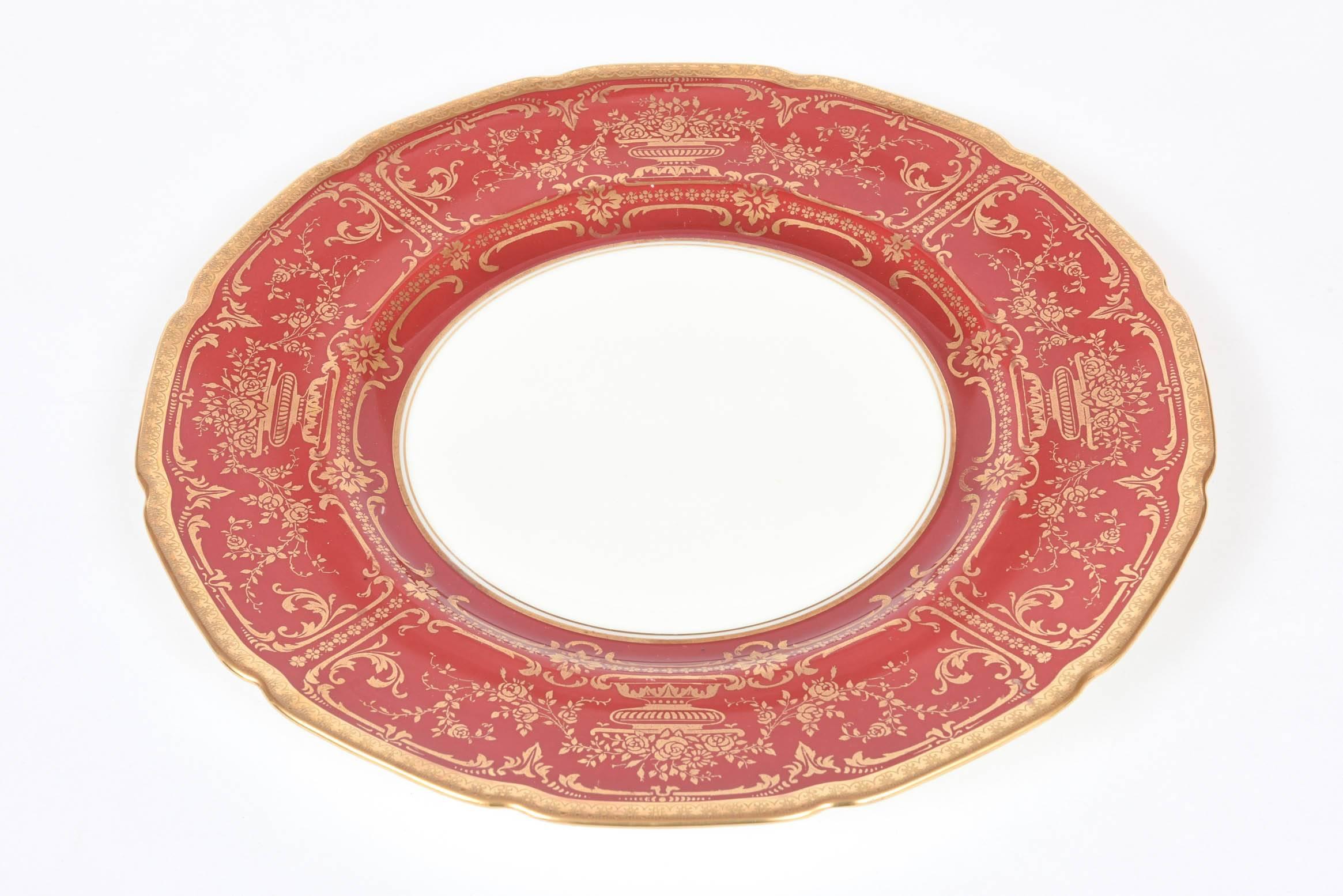 A great set of regal ruby red and gilt foliate designed dinner plates with a vibrant collar. Royal Doulton's Classic shaped dinner plate and trimmed with 24 karat acid etched gold banding. A little extra wide collar to show off the pattern of floral