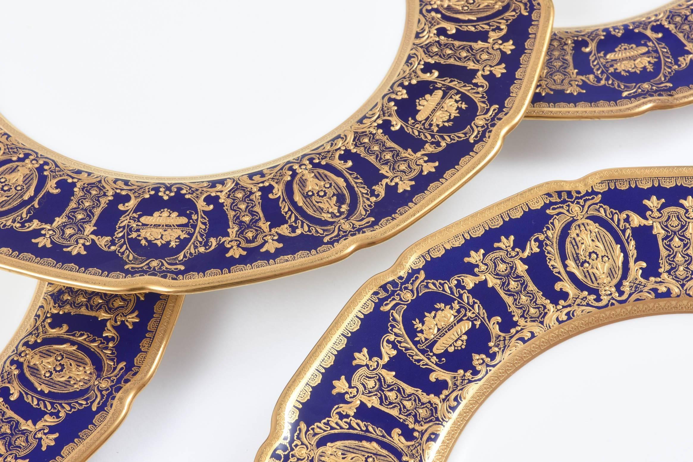 A Classic shape from Royal Doulton and custom ordered through the fine gilded age retailer of Tiffany & Co New York. Great raised tooled gilding on a shaped cobalt blue collar. Crisp white porcelain and clear centers make these perfect dinner