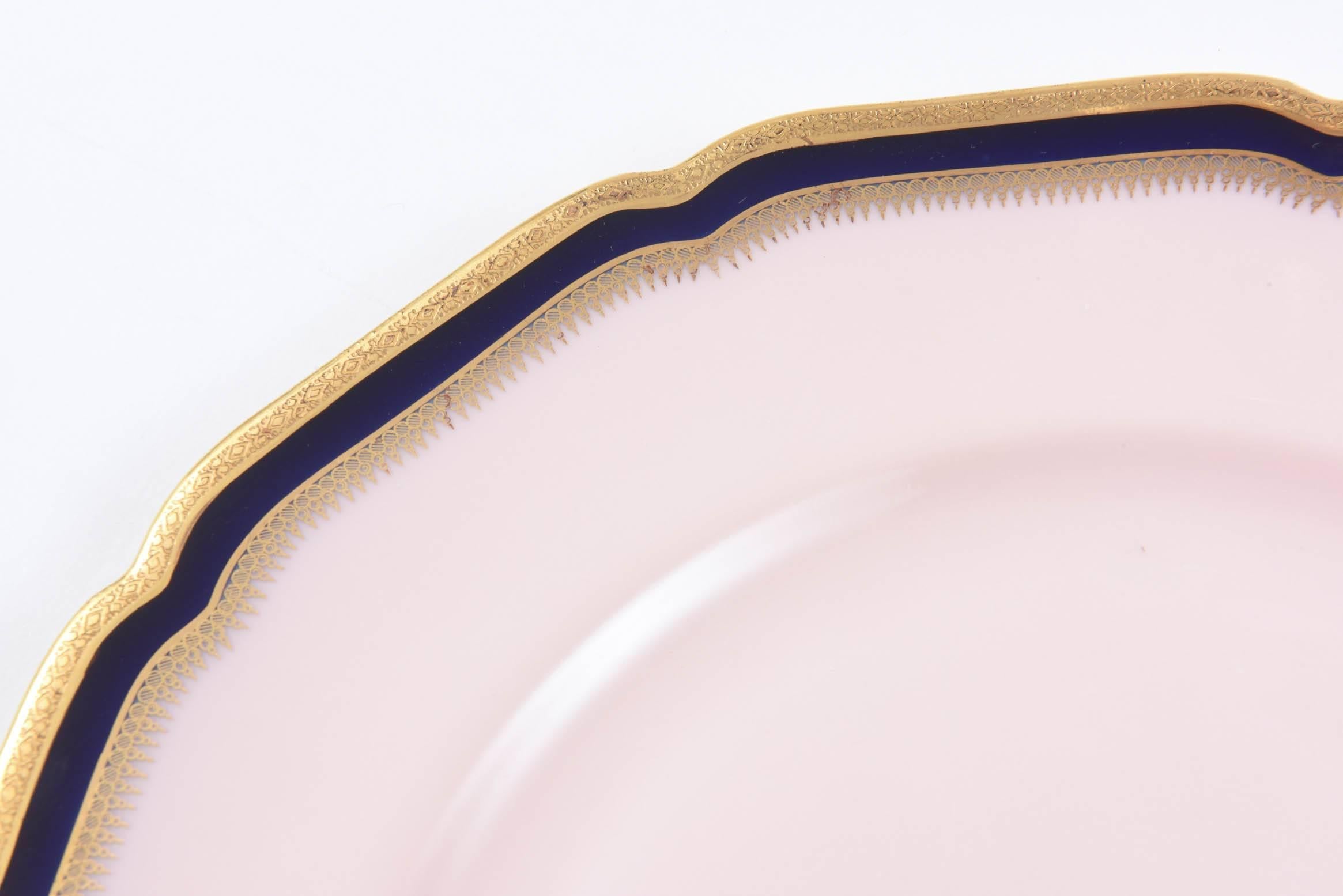 We are having so much fun mixing these uniquely colored black knight decorated dinner plates. They have a Classic shaped design and an all-over pink back ground. Then a cobalt blue band was added to the collar along with a nice acid etched 24-karat