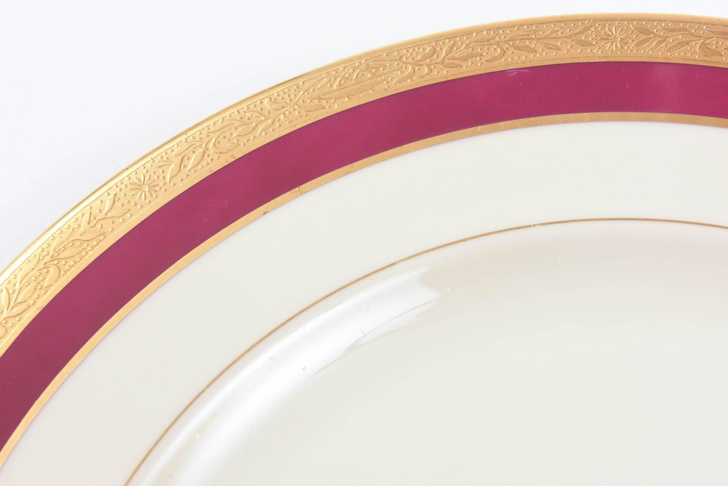 A nice sized plate elegantly decorated on the collar with a ruby band and featuring an acid etched 24-karat gold band. Perfect to mix and match in with all your fine tabletop.