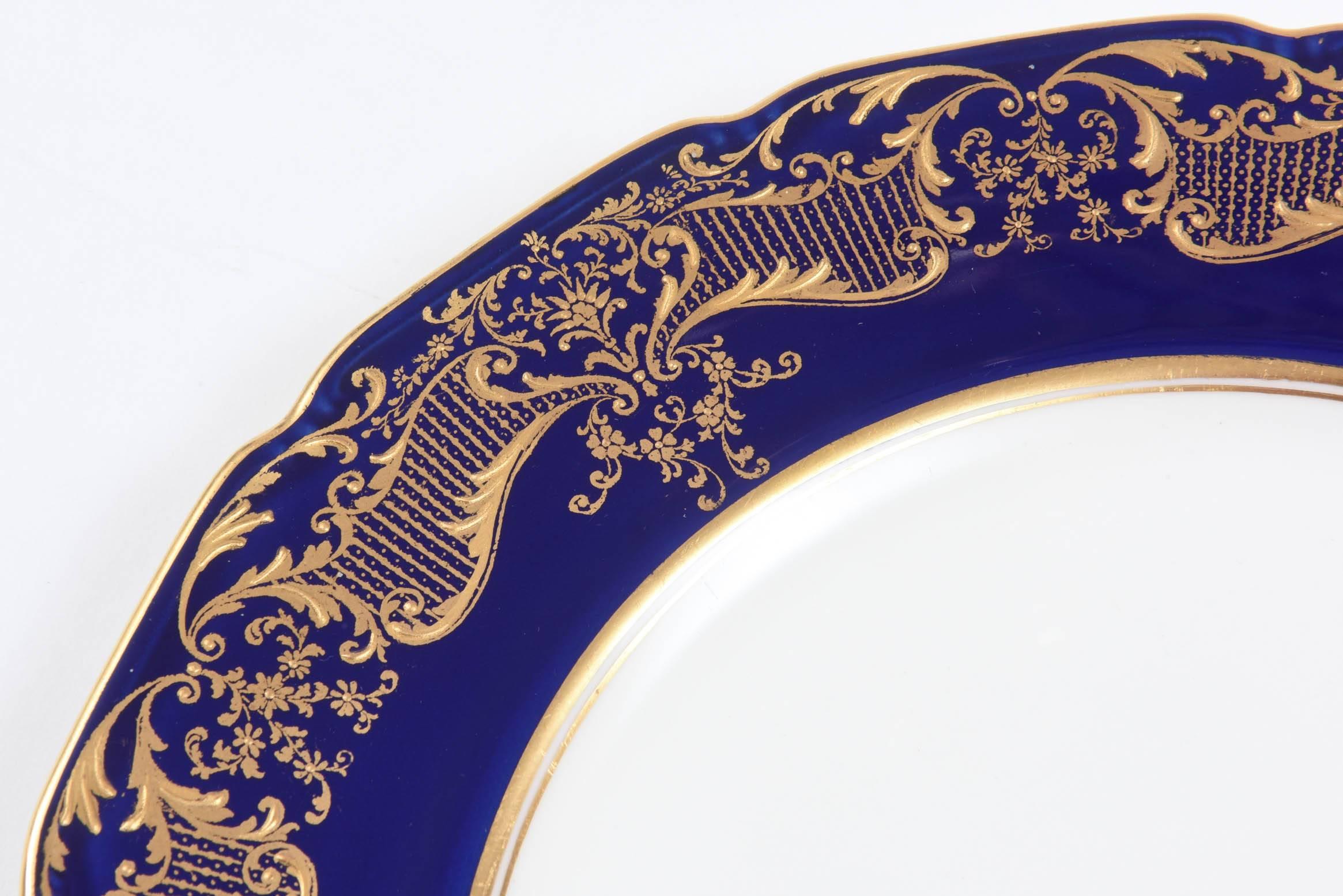 A classic shape by Royal Doulton England and Circa 1920. We love the elegant raised tooled gilding on the cobalt blue collars. Crisp white porcelain and nice clean centers. Ready to mix and match in with all your fine table top. Great Antique