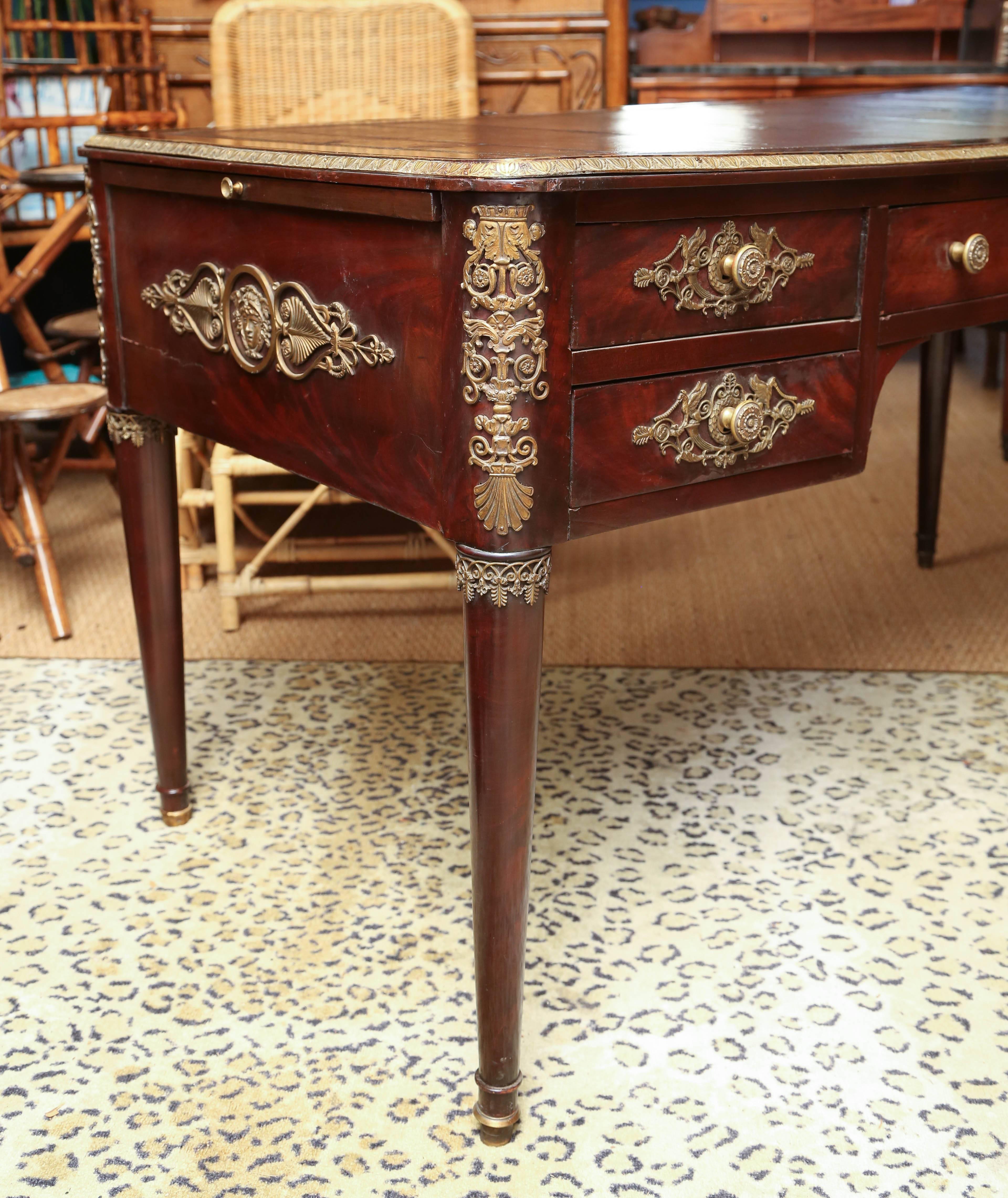 This is a superb quality French Empire partners desk with dummy drawers to the one side, the top with an inset leather surface which is old and could do with replacing, with heavy duty bronze banding, also bronze to the legs drawers. Above a case