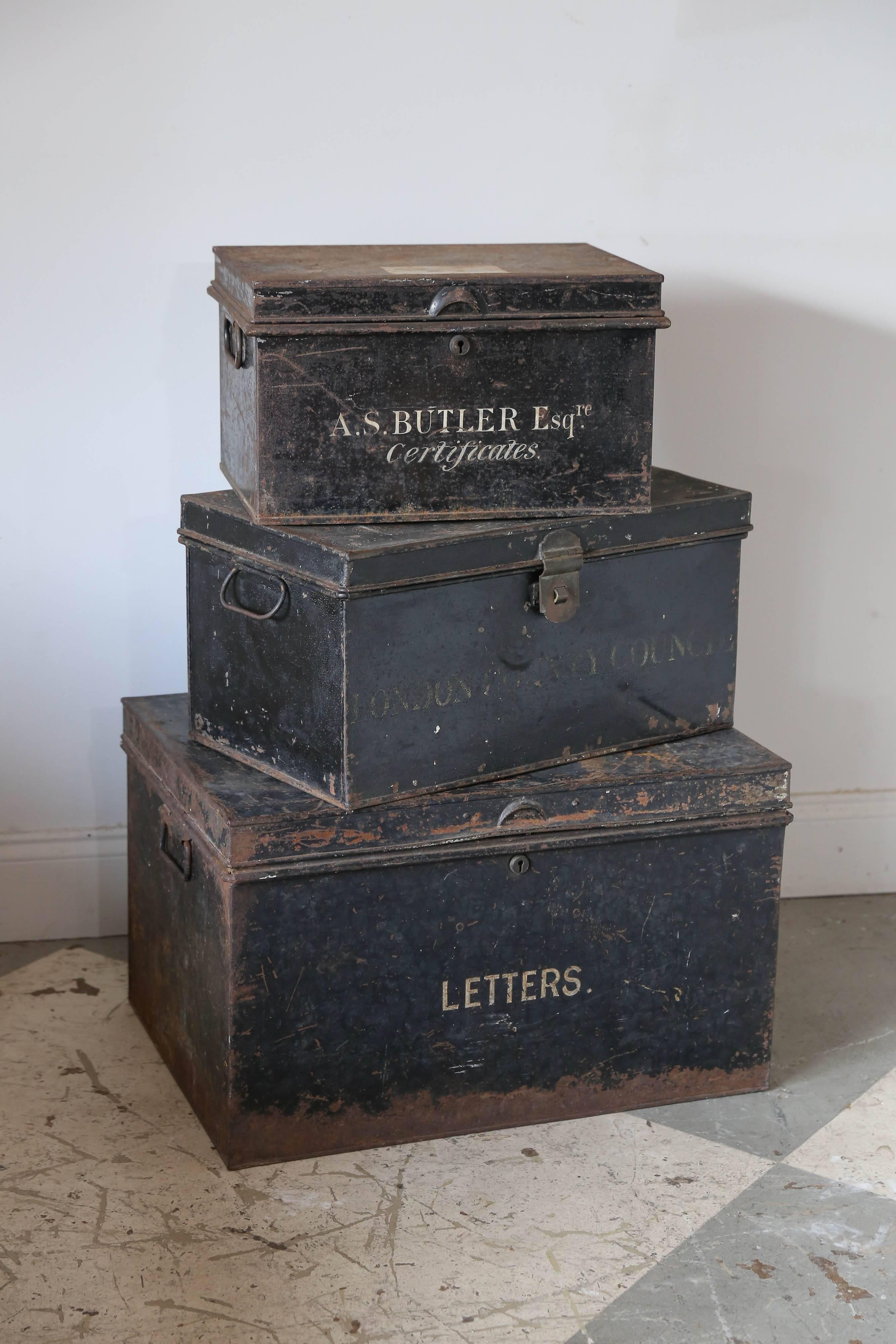 This set of metal document boxes was sourced in France and each features original lettering on the outside and painted interiors. The mid-sized box is sectioned into two spaces inside, while the smallest and largest of the set are not. The smallest