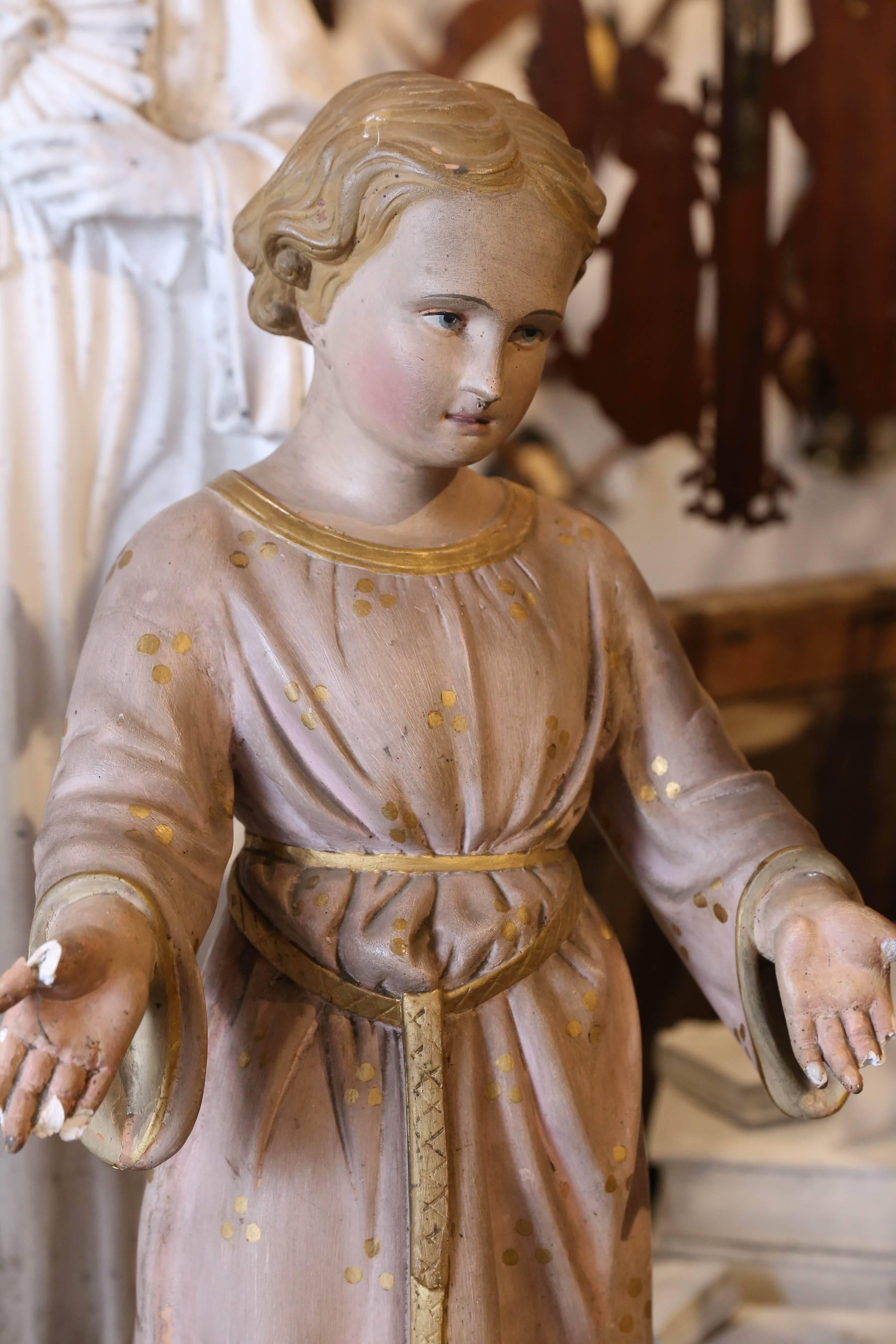 This plaster statue of Saint John is hand painted with lovely details such as the gilt pattern of his robes and delicate facial features. We sourced this piece in France and it is believed to date to around 1900. The robes are a muted dusty rose