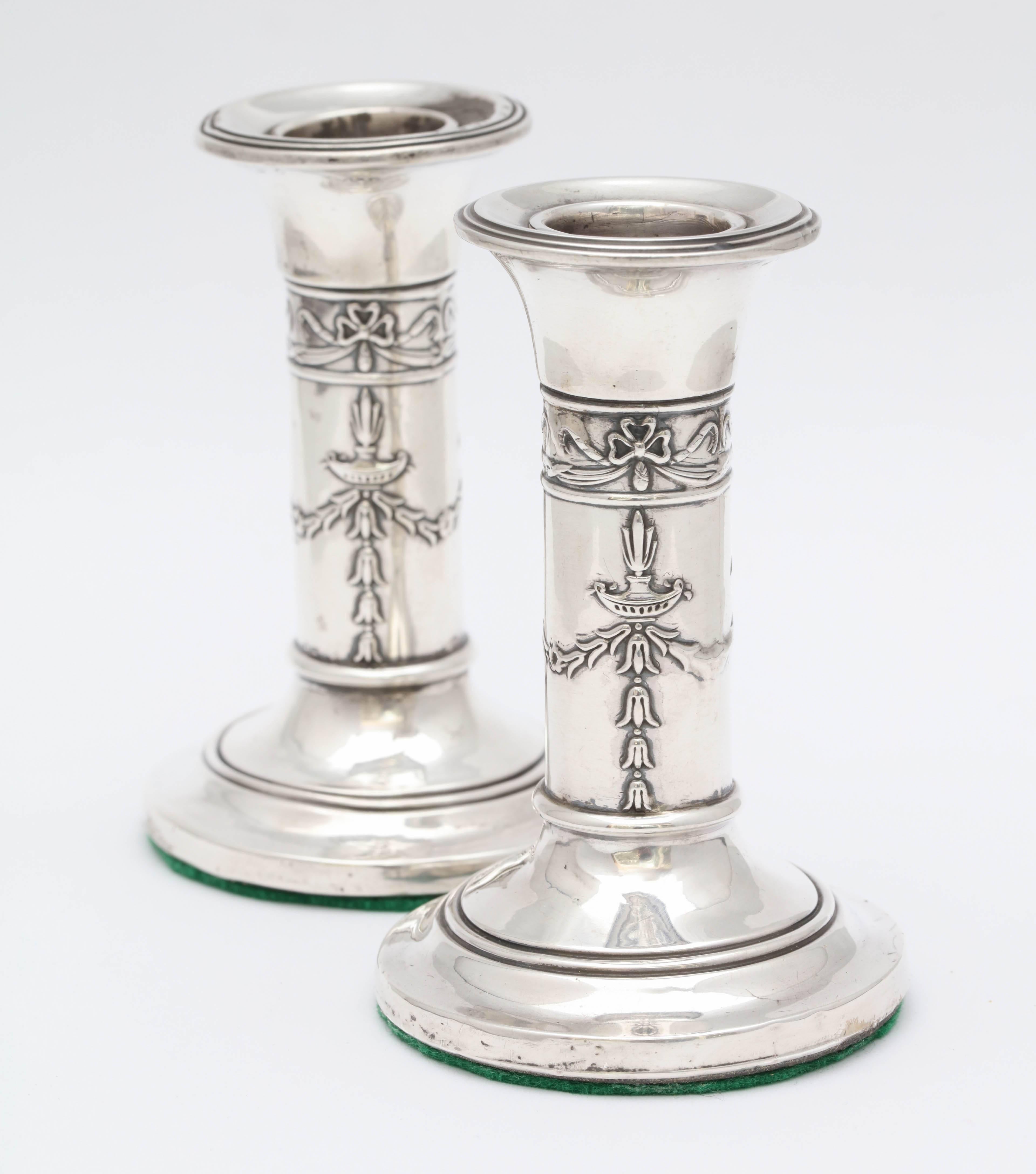 Lovely, small pair of Edwardian, sterling silver candlesticks, Birmingham, England, 1906, Levi and Salaman - makers. Pretty design on columns. 4 inches high x 2 1/2 inches diameter across base of each. Weighted. Both have some minor dints (see