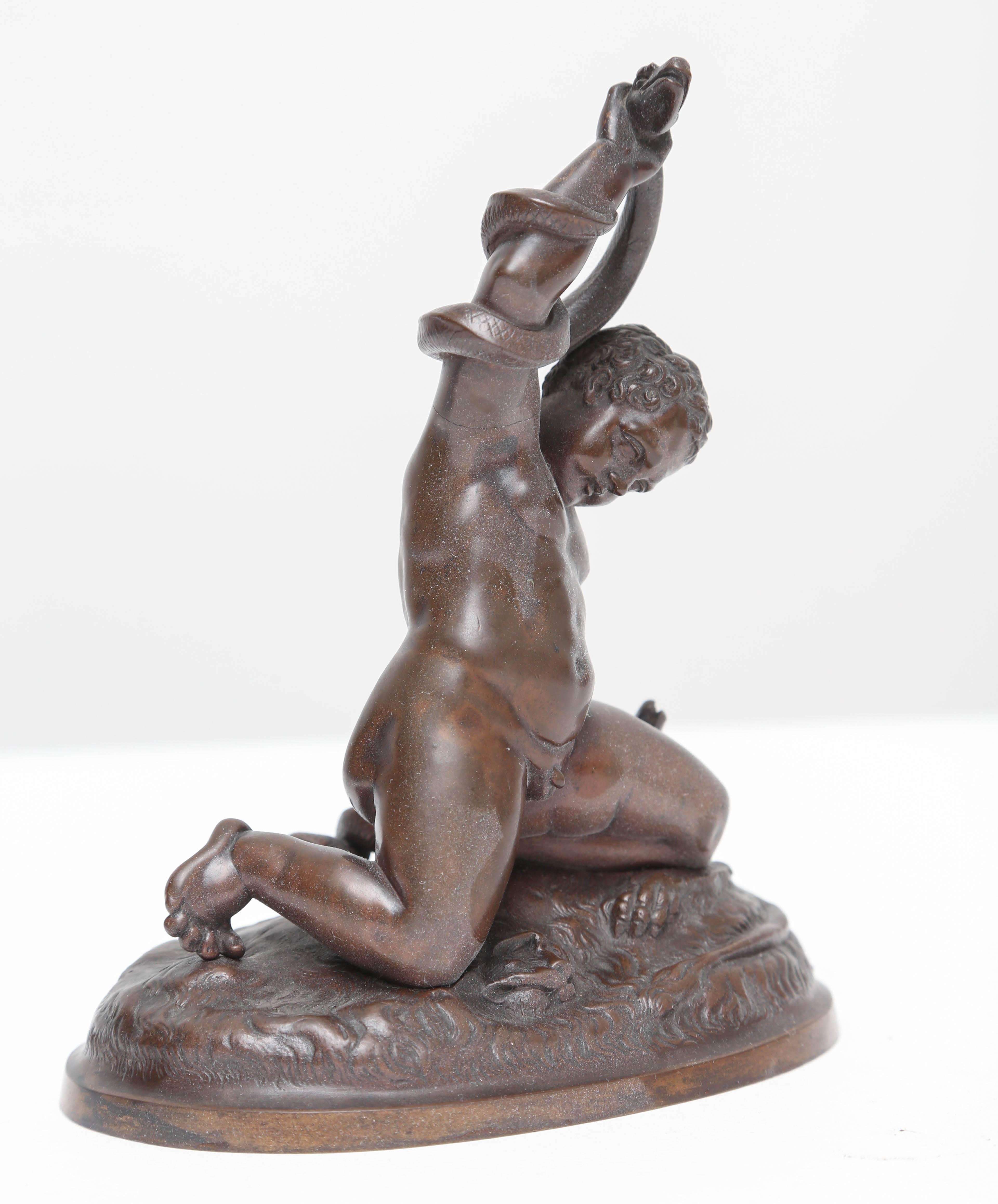 This early Grand Tour bronze of the child Hercules wrestling serpents depicts an event in his young life which showed his strength and heroism.