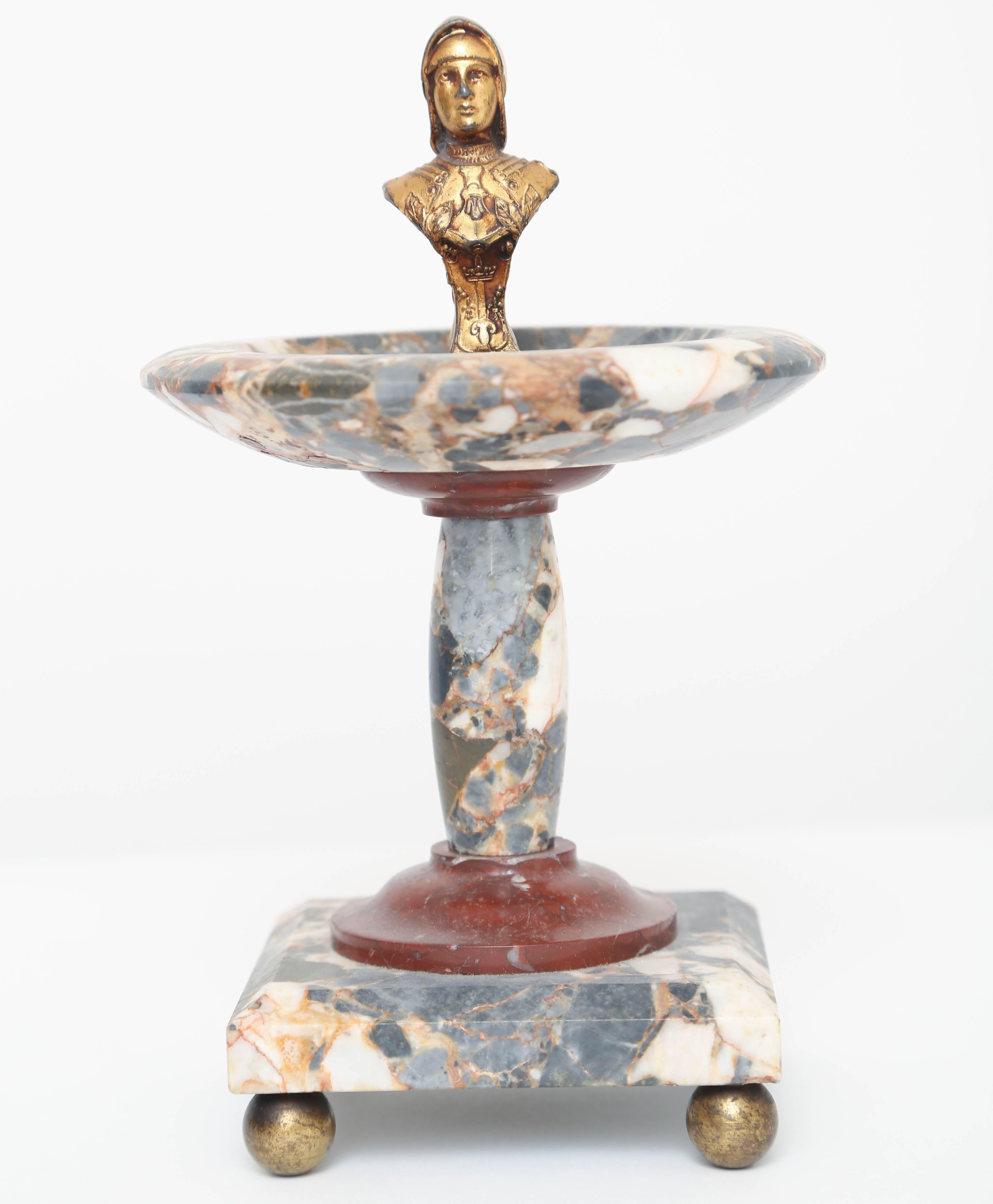 Turned breccia and antico rosso marble tazza on column supported by gilt bronze ball feet. The top is fitted with a finial gilt bronze bust of the French heroine Joan of Arc.